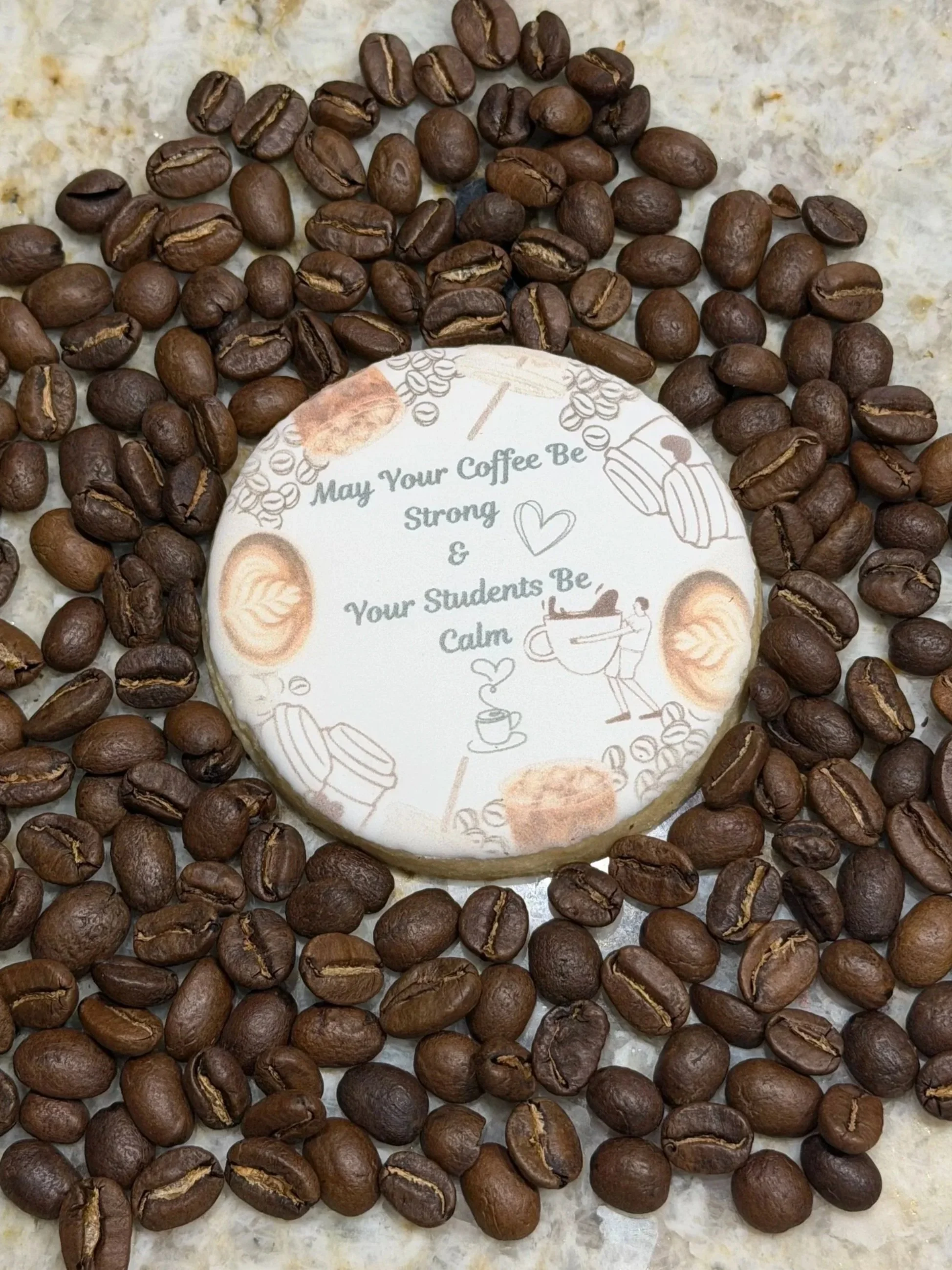 Custom coffee theme sugar cookie on top of coffee beans