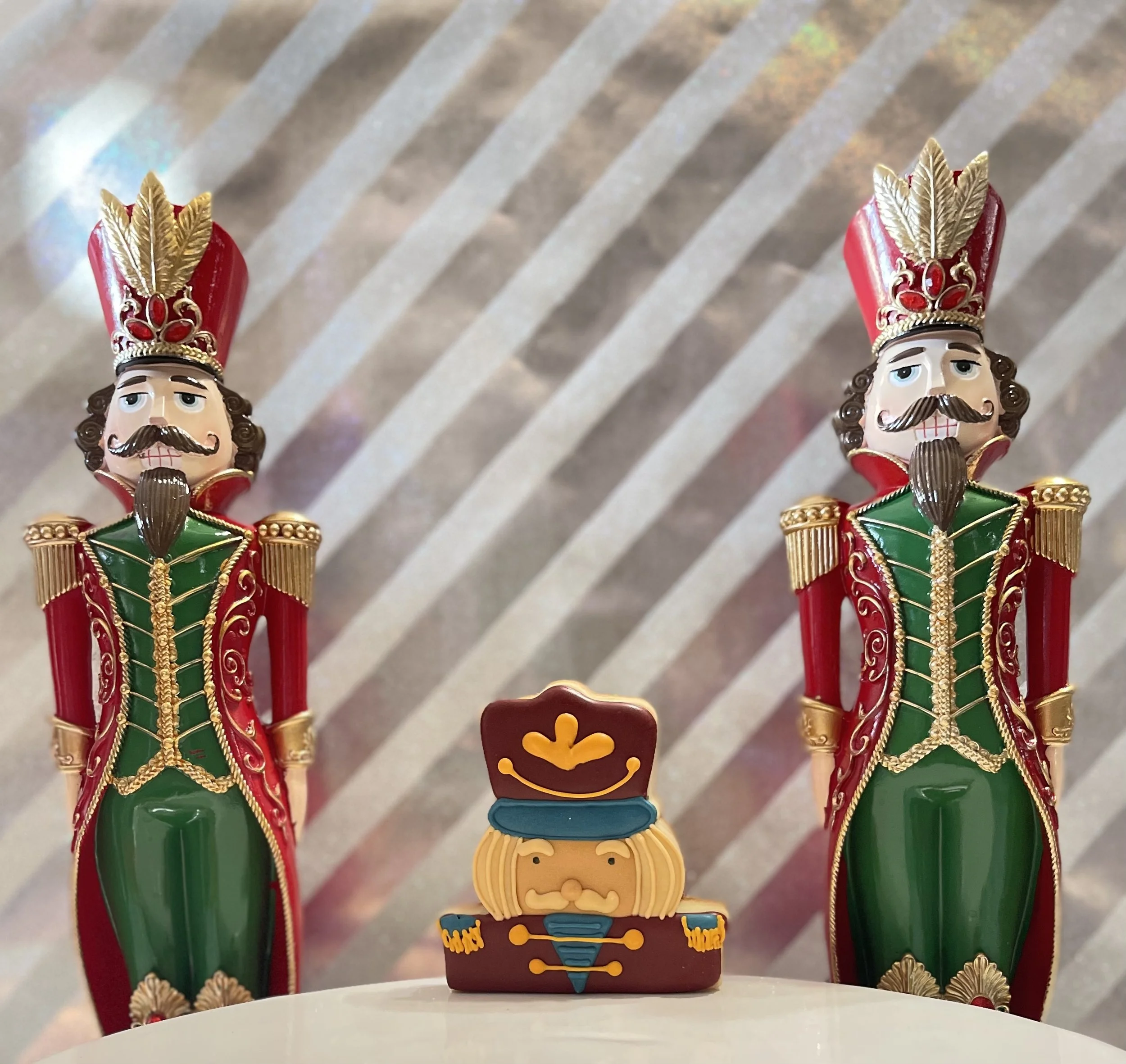 Nutcracker cookie between holiday figurines