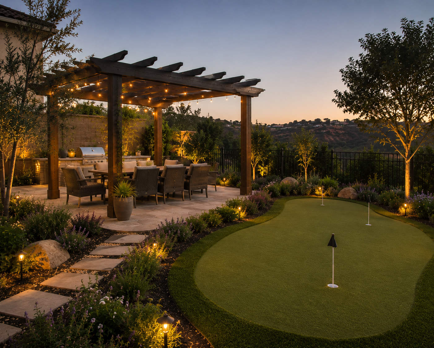 Backyard outdoor living space featuring a pergola with string lights, putting green, outdoor dining area, illuminated plants, and scenic hillside views.