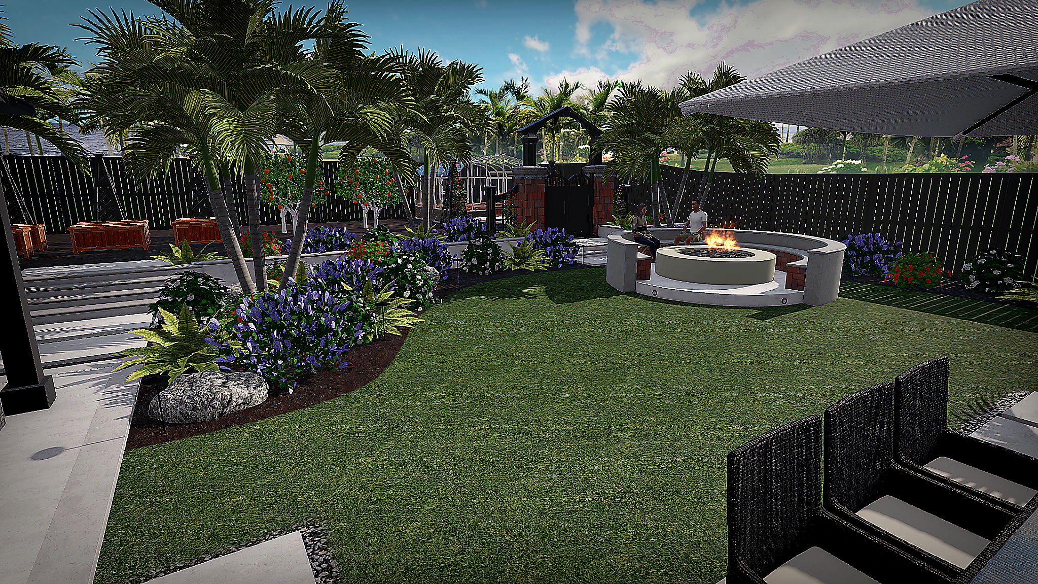 A landscaped backyard with a lush green lawn, tropical plants, purple flowers, and trees. There is a fire pit with two people sitting around it, and a fence surrounds the yard. Outdoor seating and umbrellas are also visible.