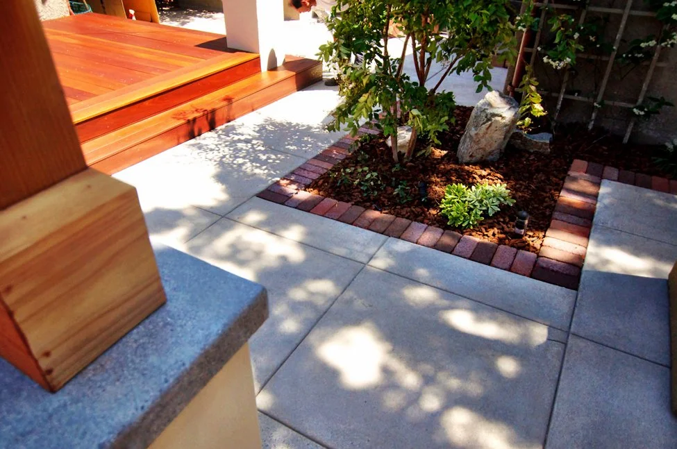 Custom built deck paired with a cement patio and brick trim in South Park, crafted by a professional contractor near me, delivering high-quality construction, durable materials, enhanced outdoor living, and increased property value for San Diego home