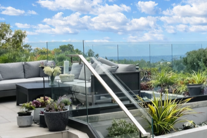 Modern outdoor patio with sectional seating and scenic landscape views