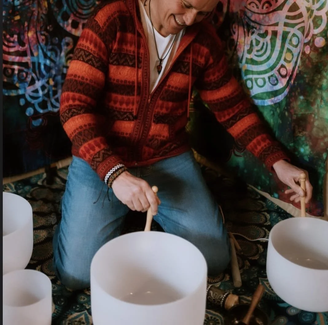 Paul playing the crystal bowls in the garden.jpeg