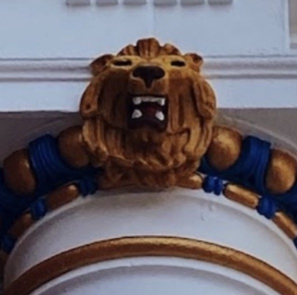 One of the four carved limestone lions crowning the exterior columns of the Advance Masonic Temple.