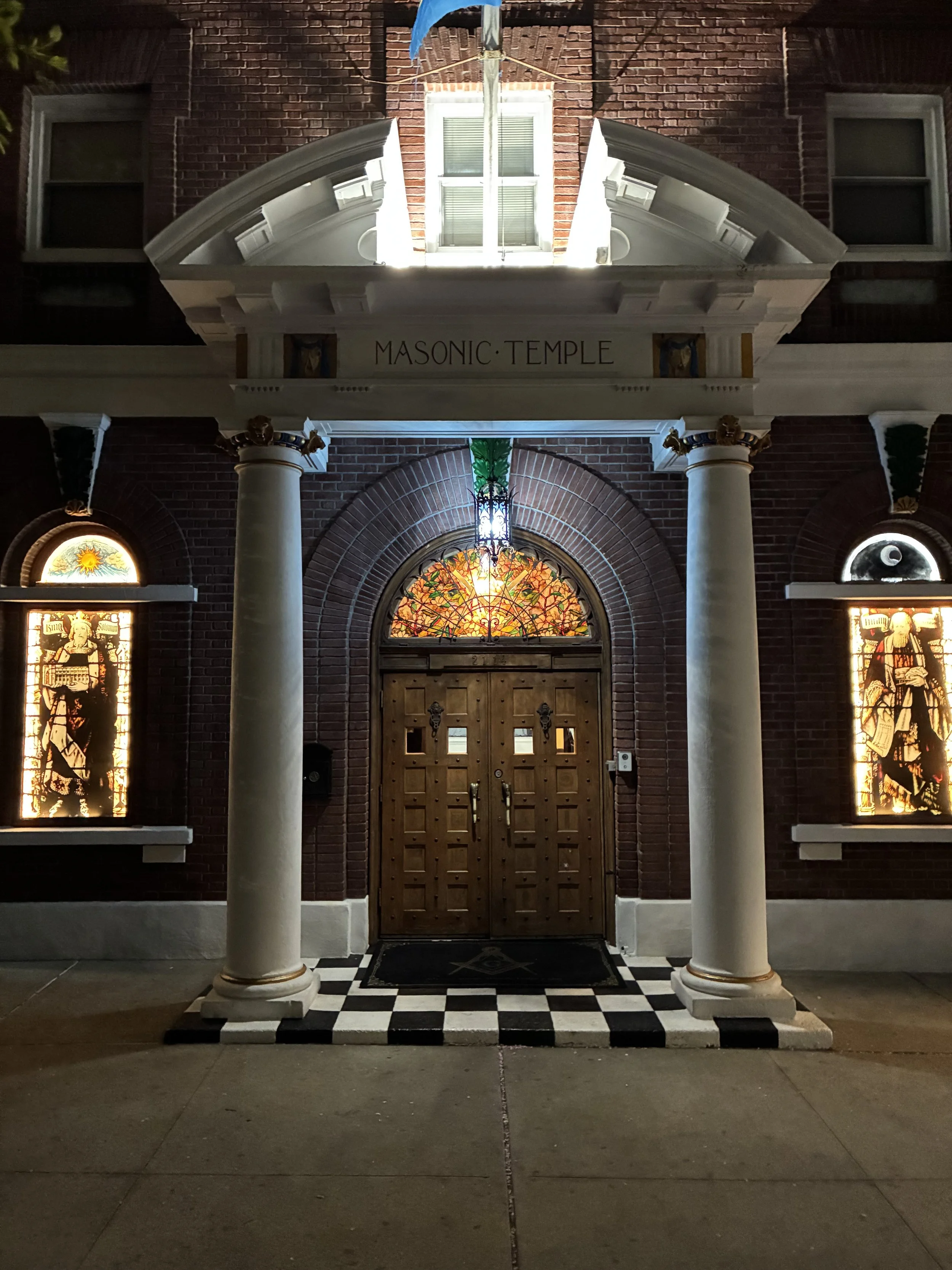 Lit Up Stained Glass of Advance Masonic lodge building in Astoria, Queens, with historical significance and classic masonry architecture, representing the rich legacy of Advance Service Mizpah Lodge No. 586.