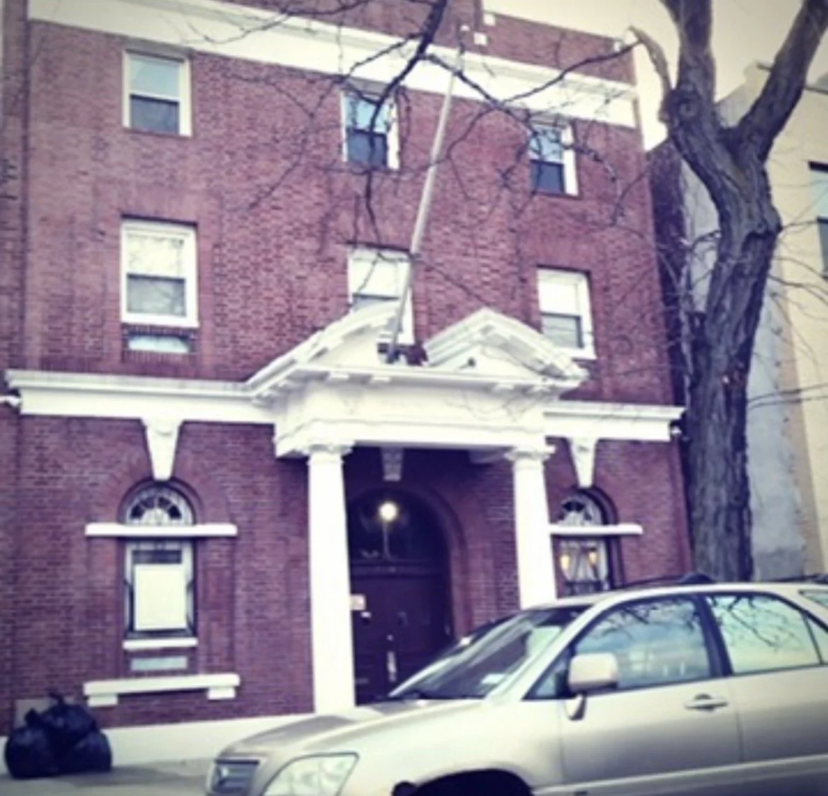 Advance Masonic Temple exterior before restoration showing worn paint and faded architectural details
