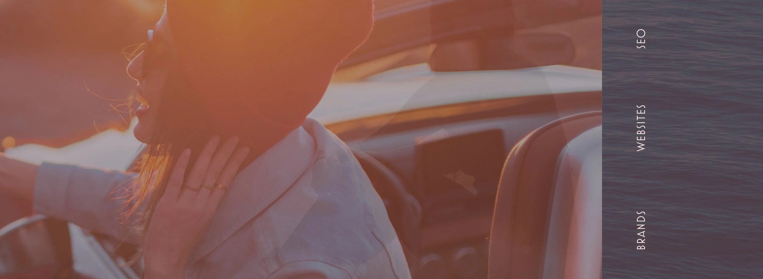 Sunset and a woman in a convertible channeling the vibes behind Aamu brand that's based on outdoors, adventure and freedom. 