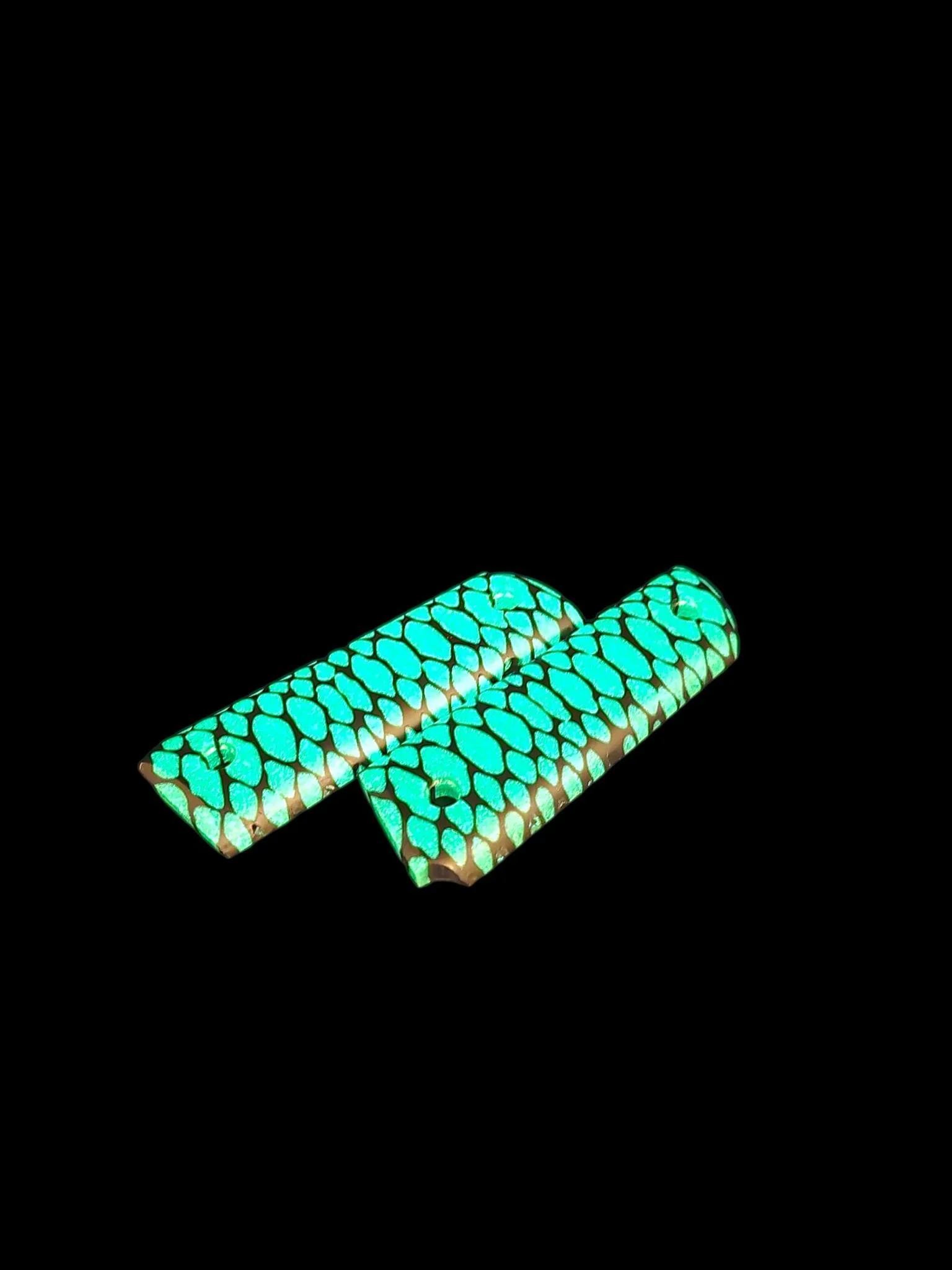 Something wild and seriously eye-catching 🐍✨
These custom grips for a 1911-style platform feature a 3D-printed snake-skin pattern filled with green glow-in-the-dark epoxy. They look amazing in daylight &mdash; but in the dark? They absolutely pop.

