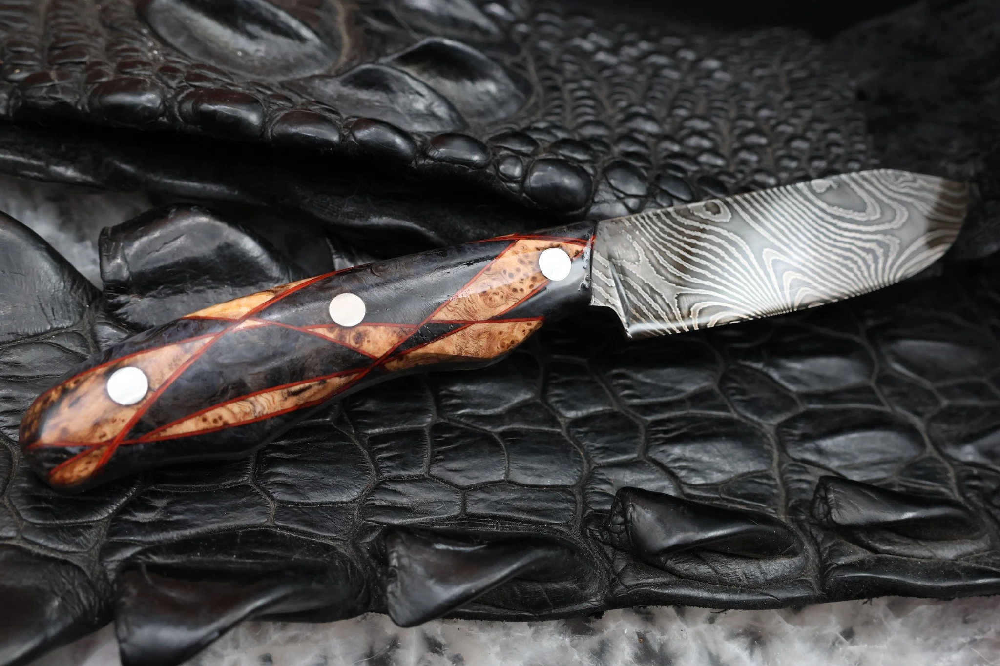 Sometimes the old ways are still the best ways.

This Damascus blade was hand forged by Iron Beak Forge out of Idaho and finished here in our Texas shop.

For the handle, we stepped away from our usual stabilized burl construction and used a more tra
