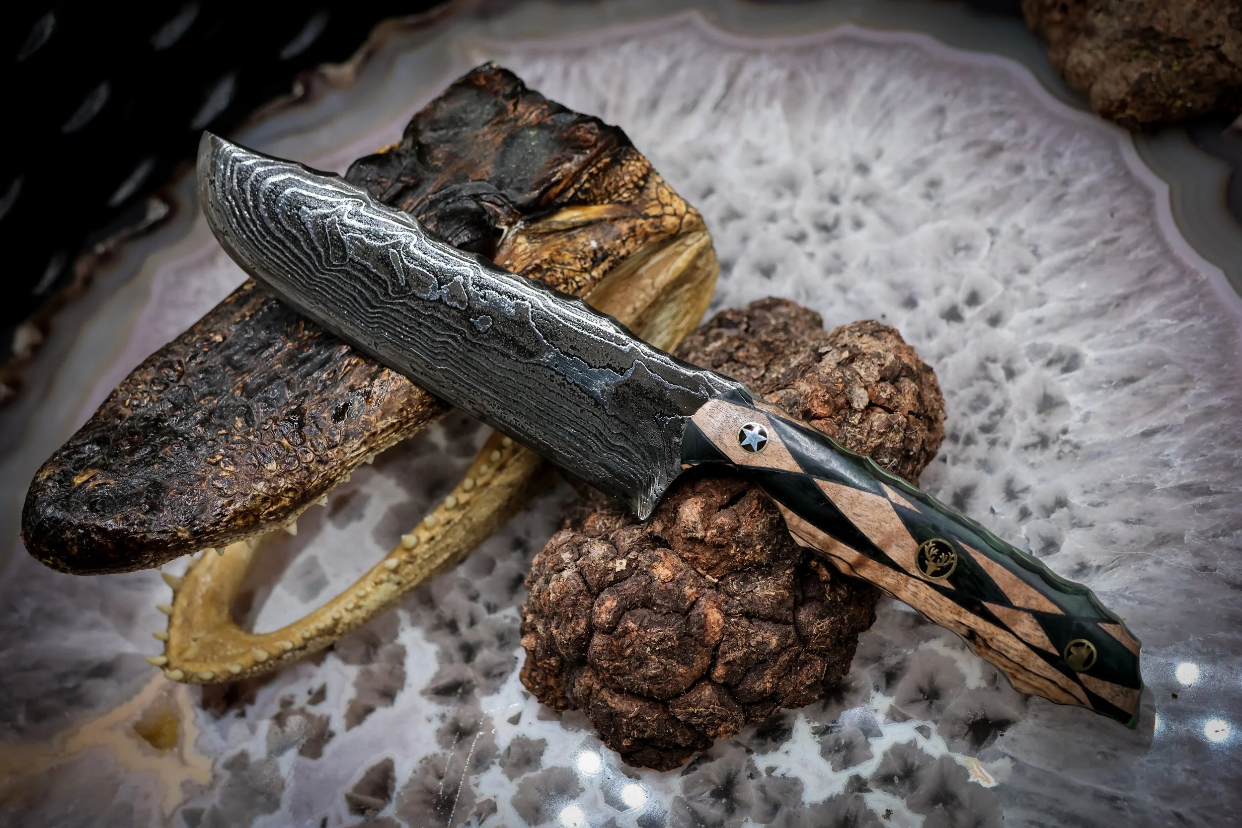 The Timberline handmade Damascus hunting knife with deep-etched 1080 and 15N20 steel blade, geometric blonde spalted maple and green-dyed redwood handle, and decorative mosaic pins..jpg