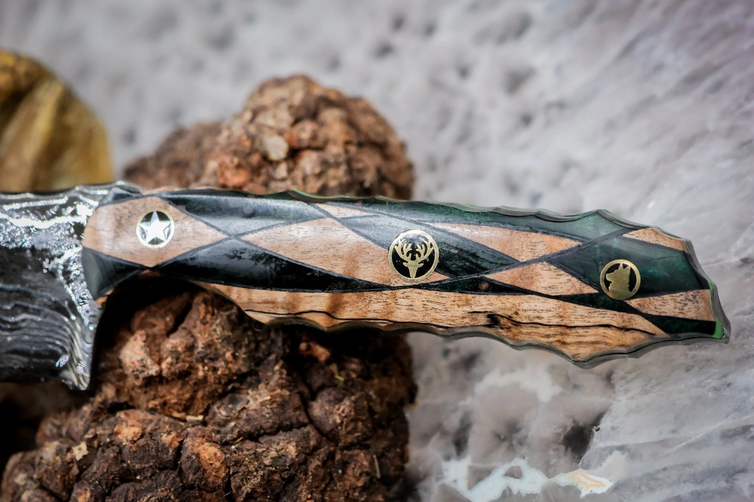 The Timberline handmade Damascus hunting knife with deep-etched 1080 and 15N20 steel blade, geometric blonde spalted maple and green-dyed redwood handle, and decorative mosaic pins.4.jpg