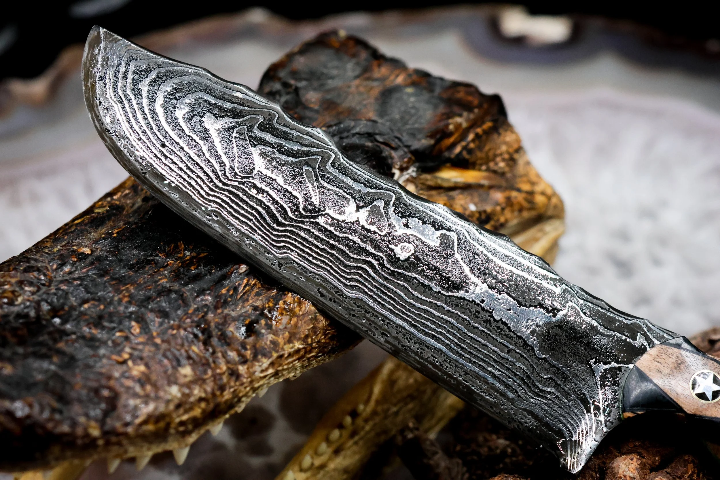 The Timberline handmade Damascus hunting knife with deep-etched 1080 and 15N20 steel blade, geometric blonde spalted maple and green-dyed redwood handle, and decorative mosaic pins.5.jpg