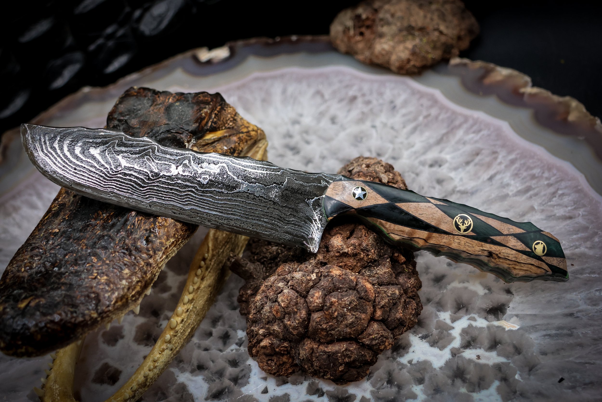 The Timberline handmade Damascus hunting knife with deep-etched 1080 and 15N20 steel blade, geometric blonde spalted maple and green-dyed redwood handle, and decorative mosaic pins.1.jpg