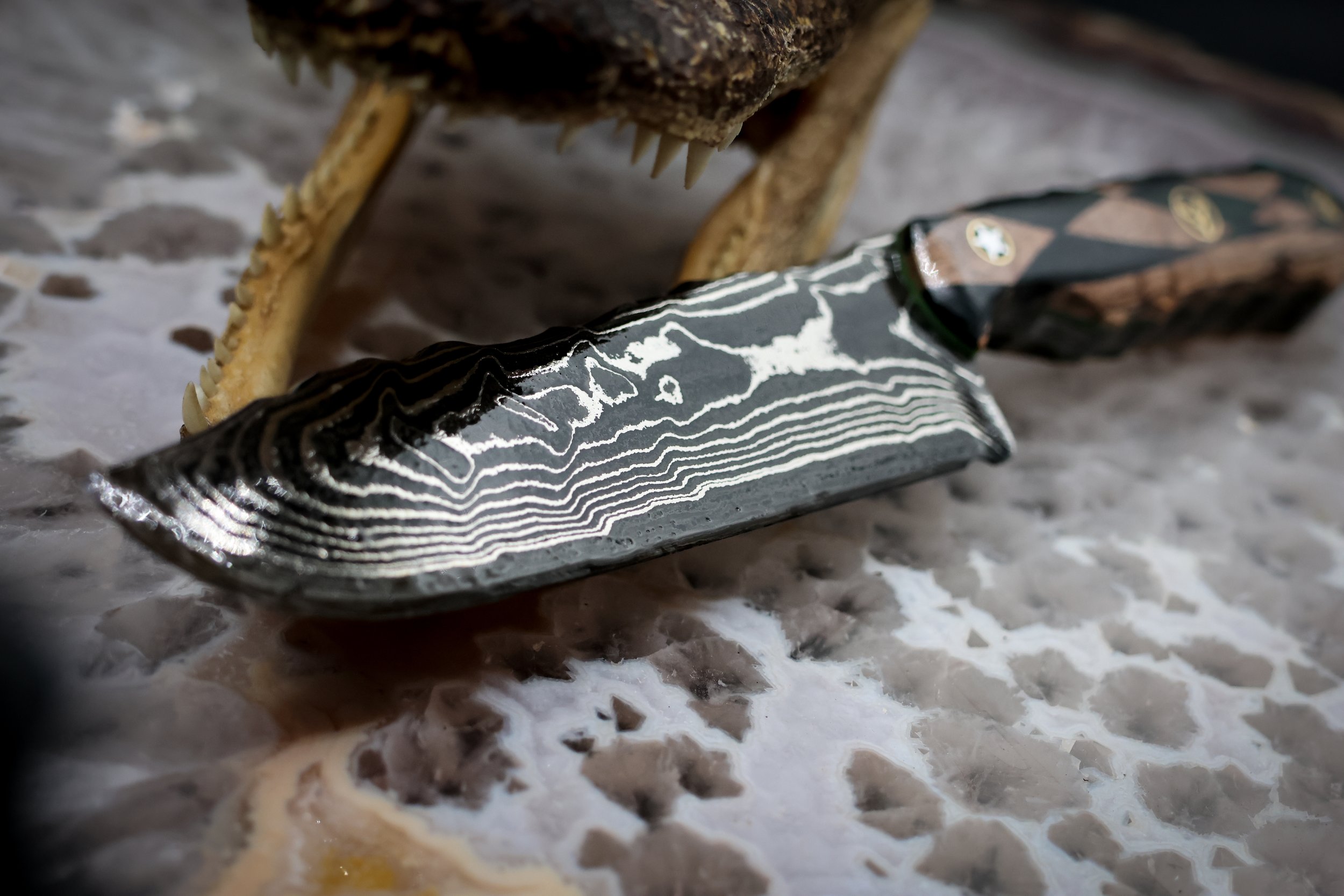 The Timberline handmade Damascus hunting knife with deep-etched 1080 and 15N20 steel blade, geometric blonde spalted maple and green-dyed redwood handle, and decorative mosaic pins.6.jpg
