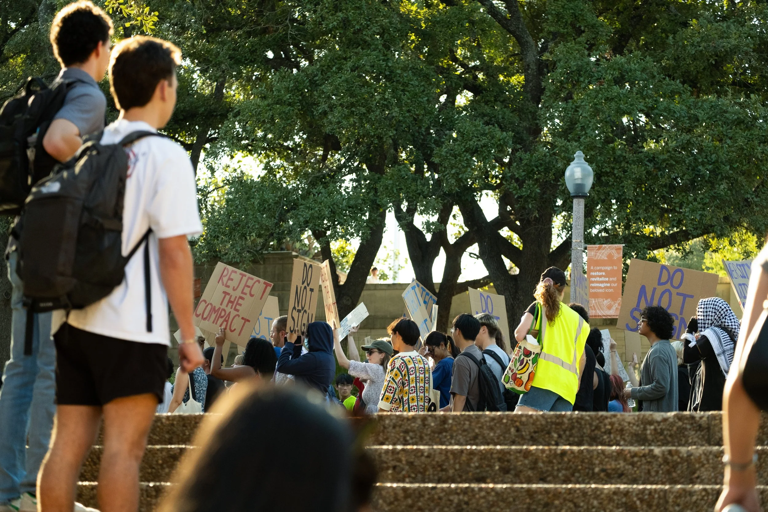 Bystanders watch as protesters march around the tower on Friday, Nov. 7. 