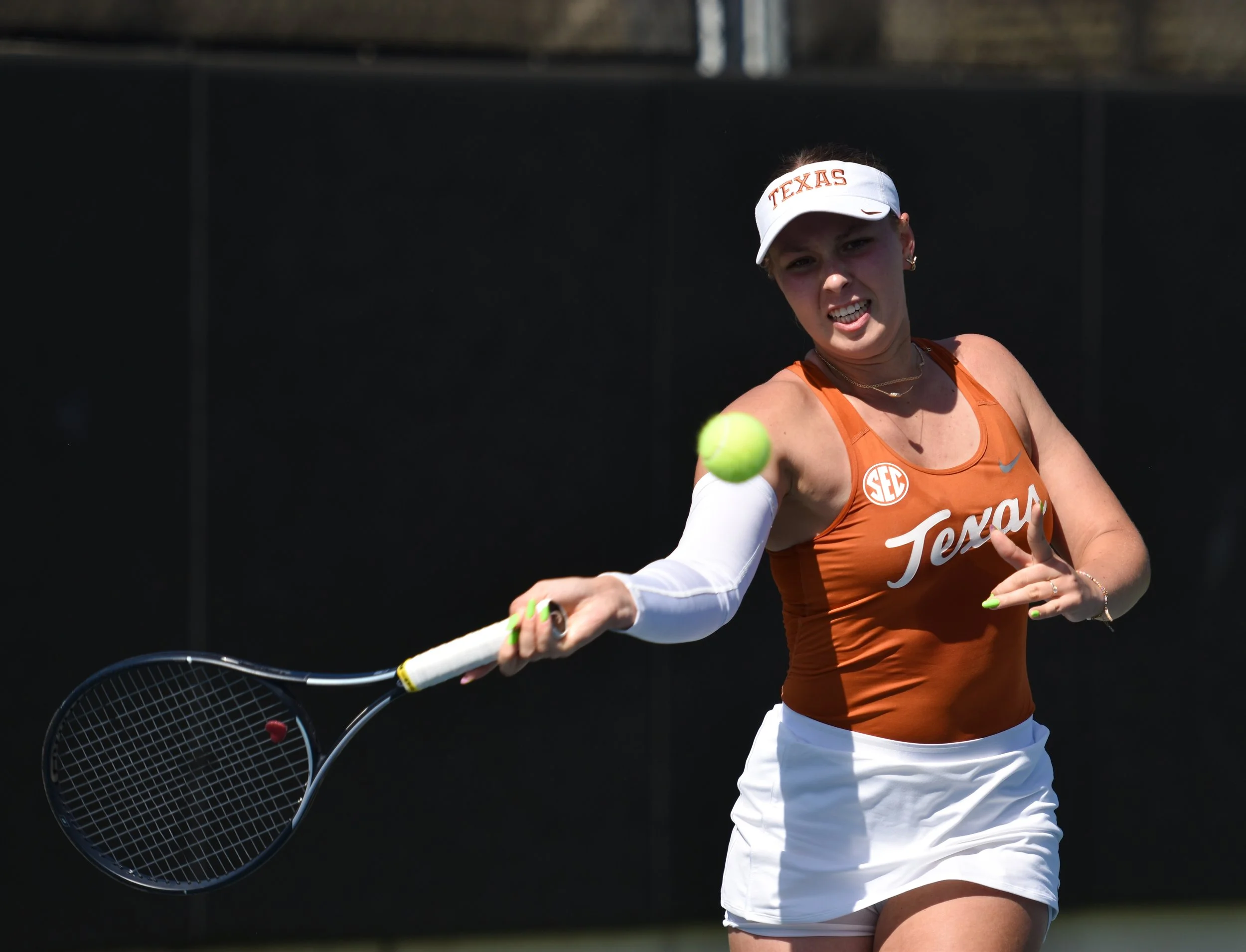 Texas tennis player Carmen Herea hits the ball to Georgia’s Anastasiia Lopata during a singles match on April 11, 2025
