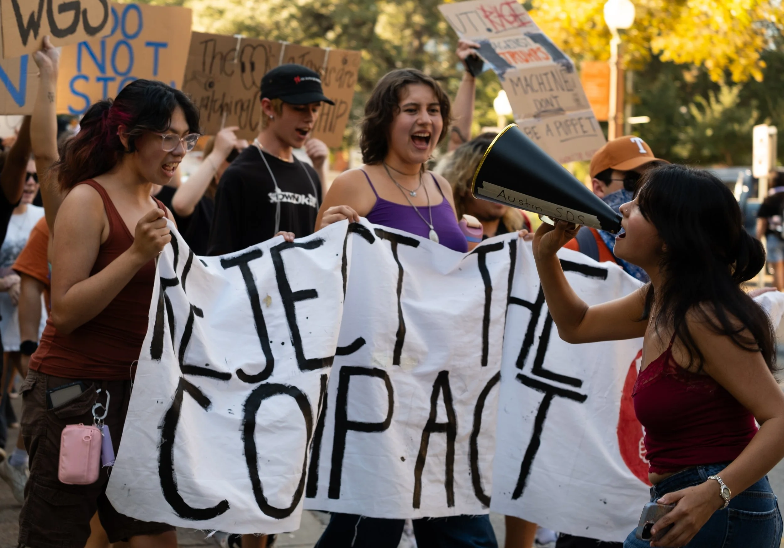 Protesters chant while being led by an SDS member as the crowd marches around the tower on Nov. 7.