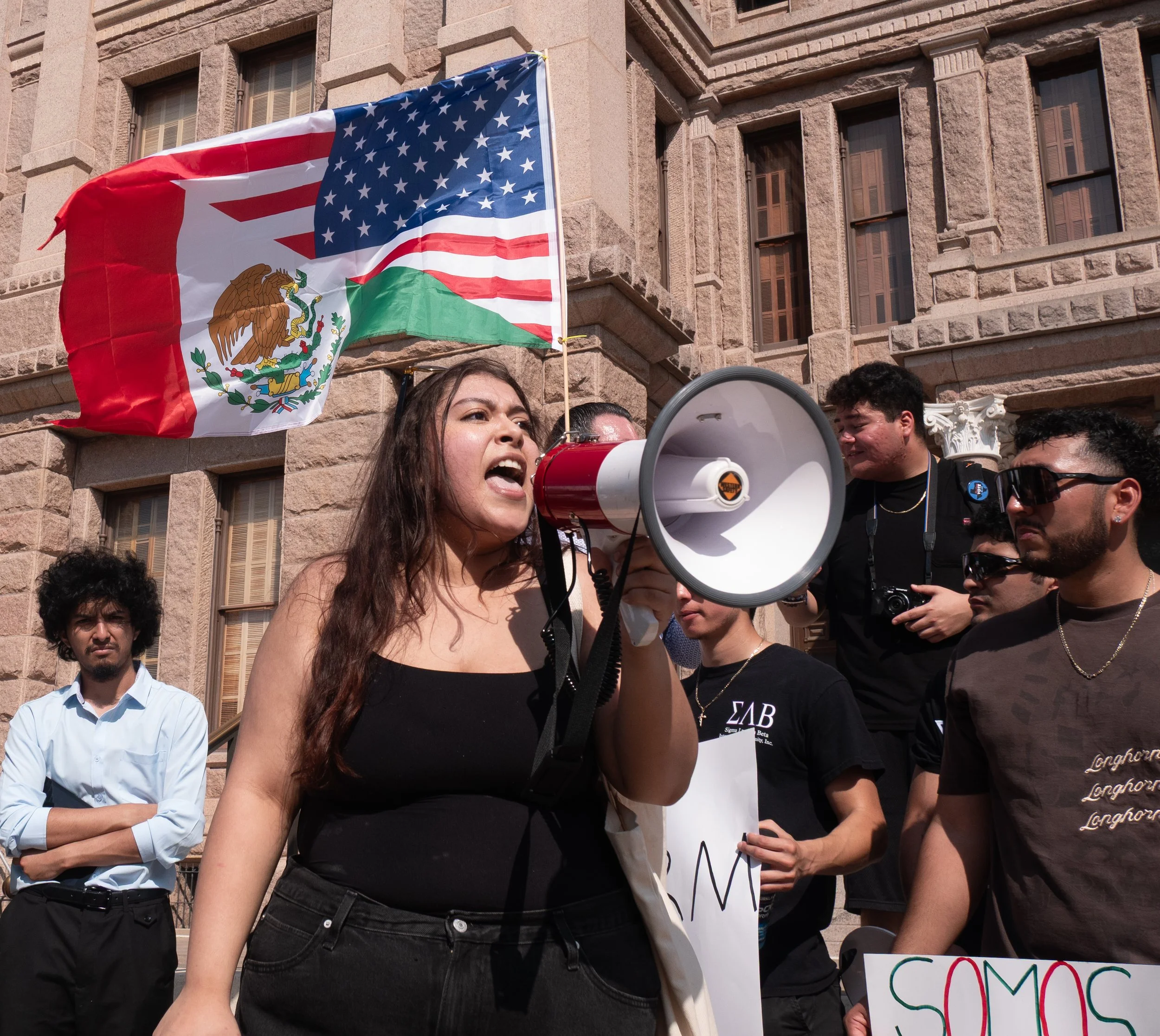 Protester speaks to crowd at fraternity Sigma Lambda Beta immigration protest at the Capitol on Feb. 8, 2025.