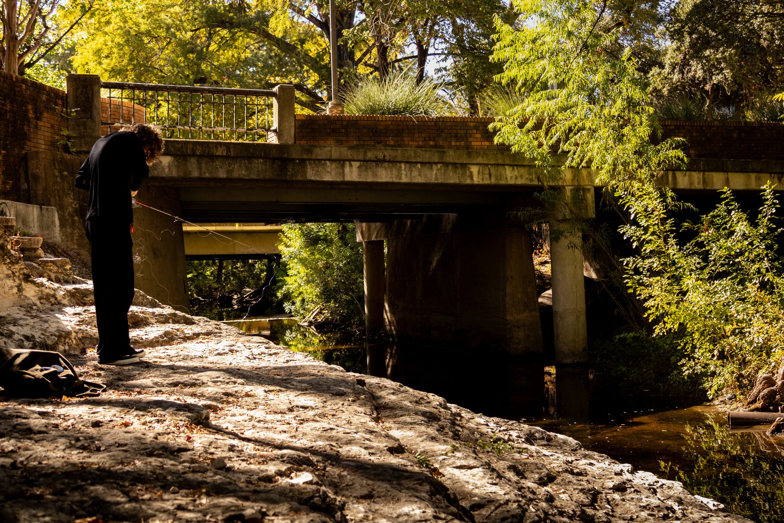 Man fishes during his break on The University of Texas at Austin's campus on Nov. 21, 2024