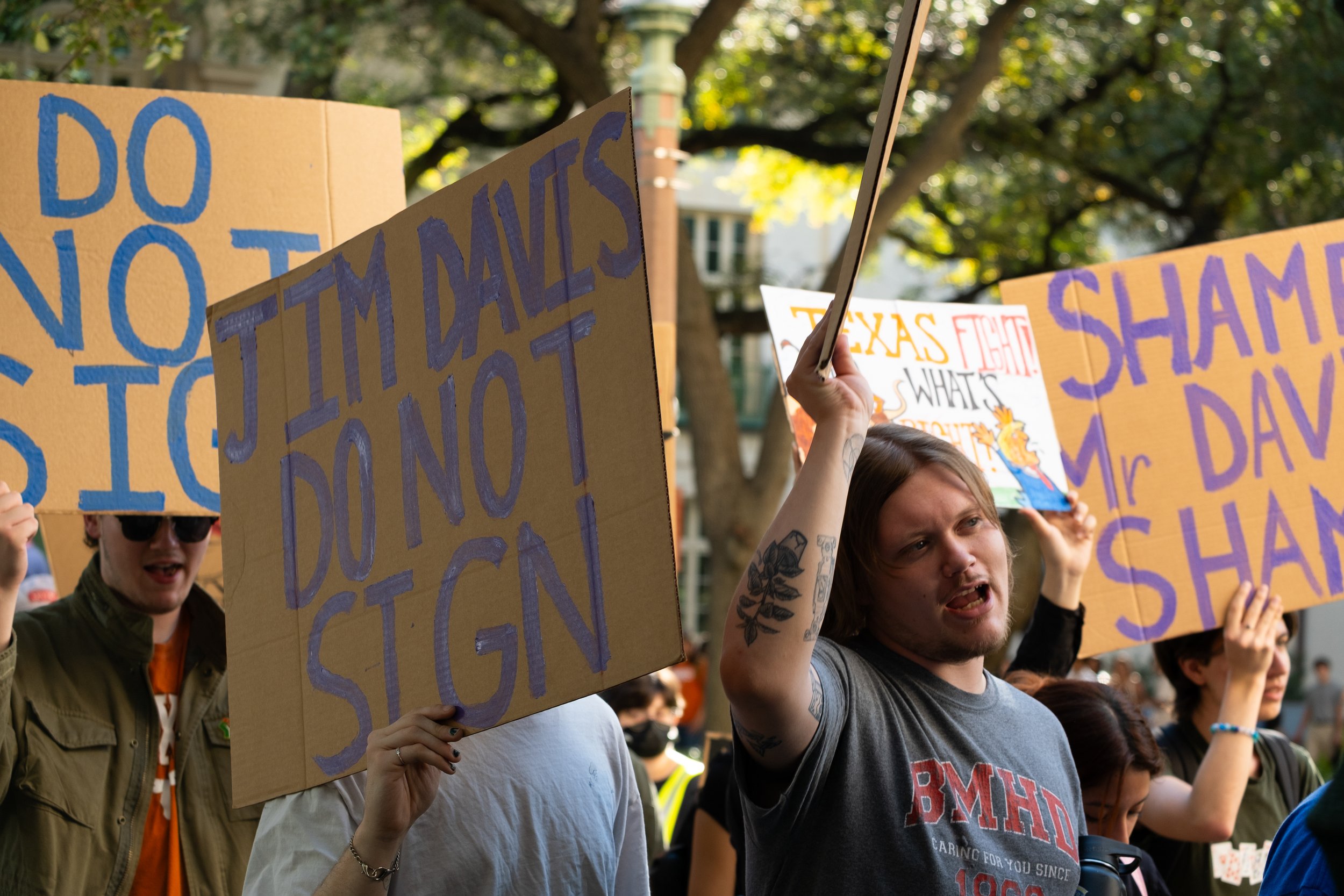 Protesters walk around the tower while chanting and holding up signs on Nov. 7. 