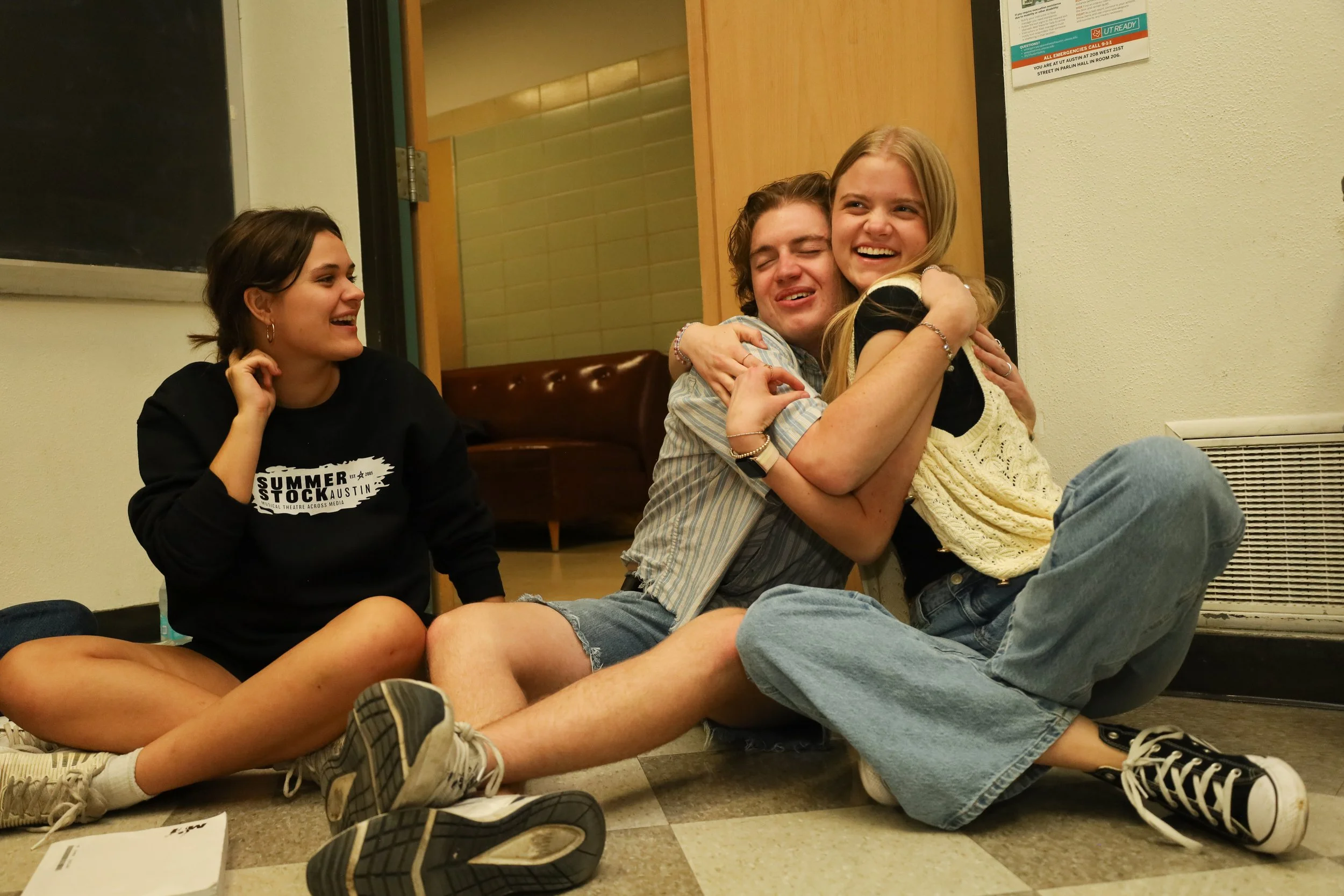 Left to right, cast members Aidan Jones and Jessica Paine hug each other at rehearsal on Oct. 15 at Parlin Hall. 
