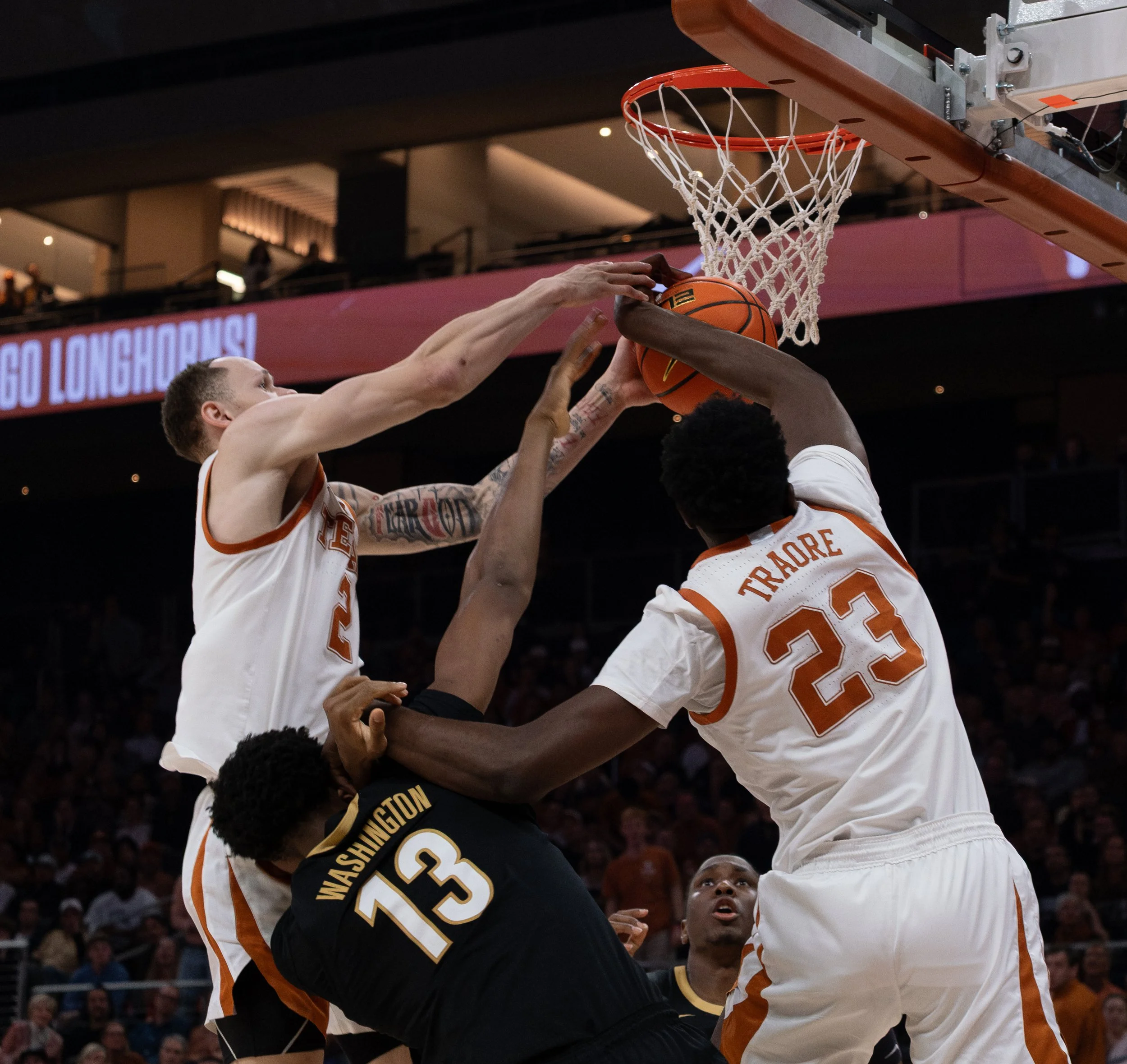 Texas' Chendall Weaver (left), Lassina Traore (right) and Vanderbilt's Jalen Washington (middle) fight for possession of the ball on Wednesday, Jan. 14.