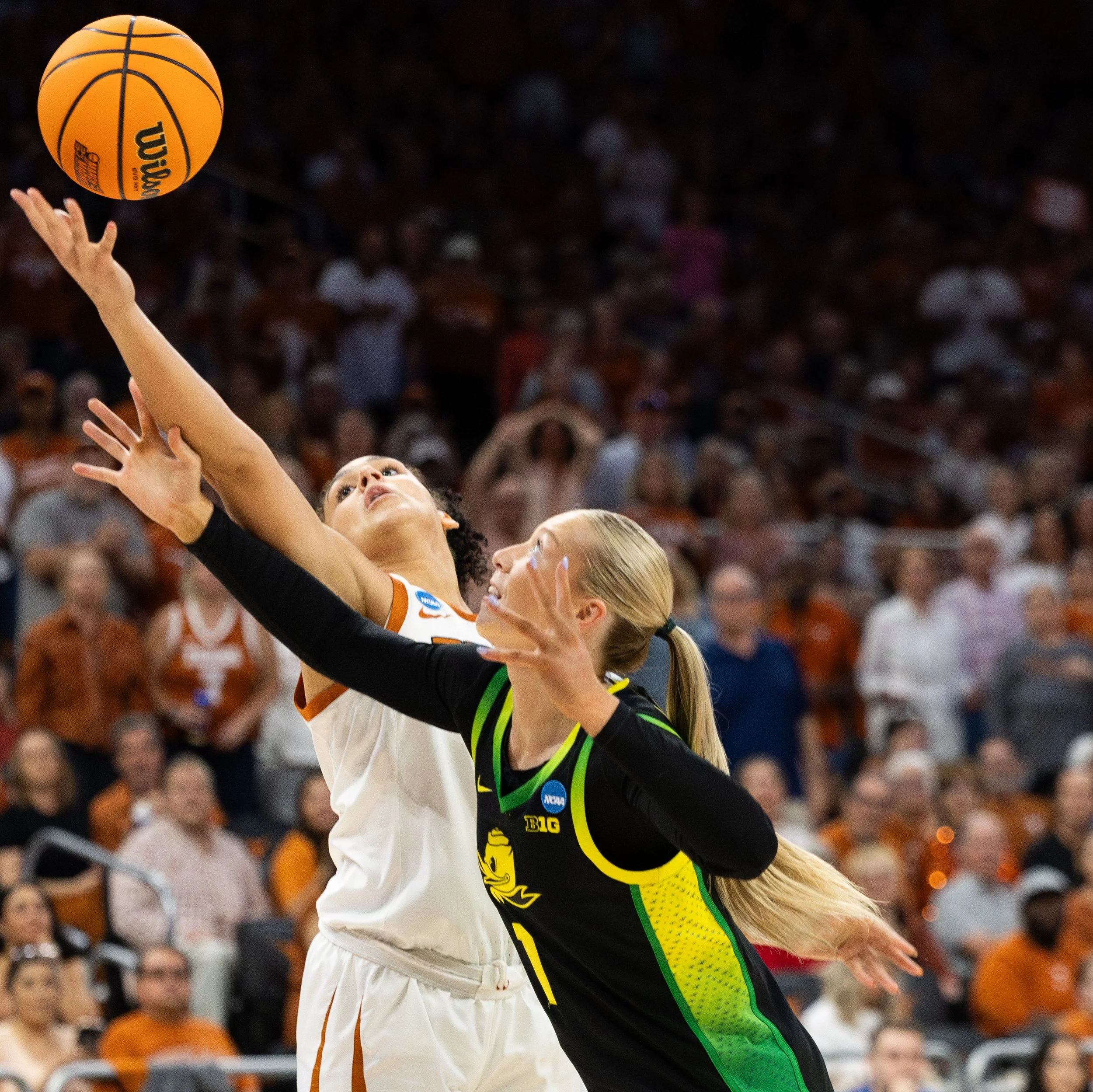 Texas sophomore front Justice Carlton and Oregon senior front Mia Jacobs reach for the ball at Moody Center on March 22, 2026. 