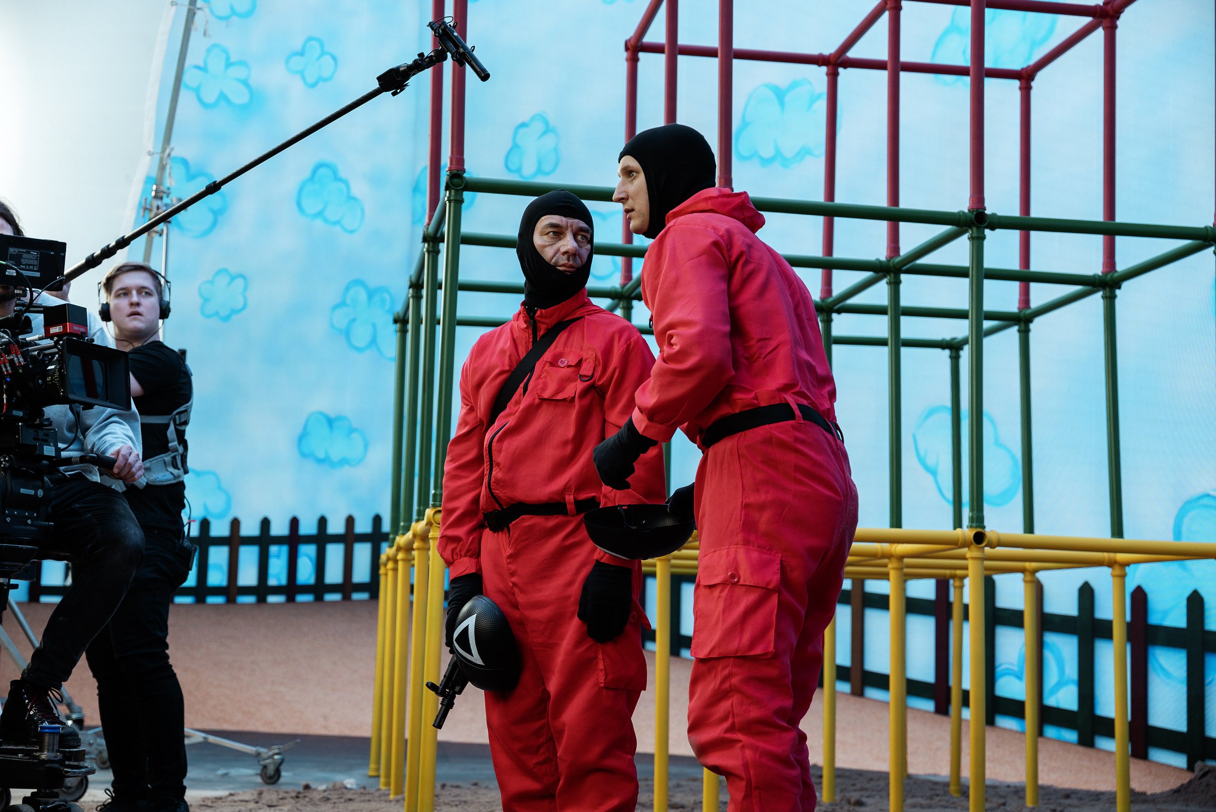 Behind-the-scenes shot of actors engaged in dialogue mid-scene on the Tet x Netflix Squid Game set — captured by Miks Ratnieks.
