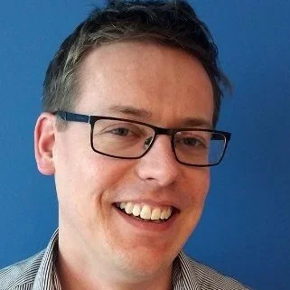 A man with glasses and short hair