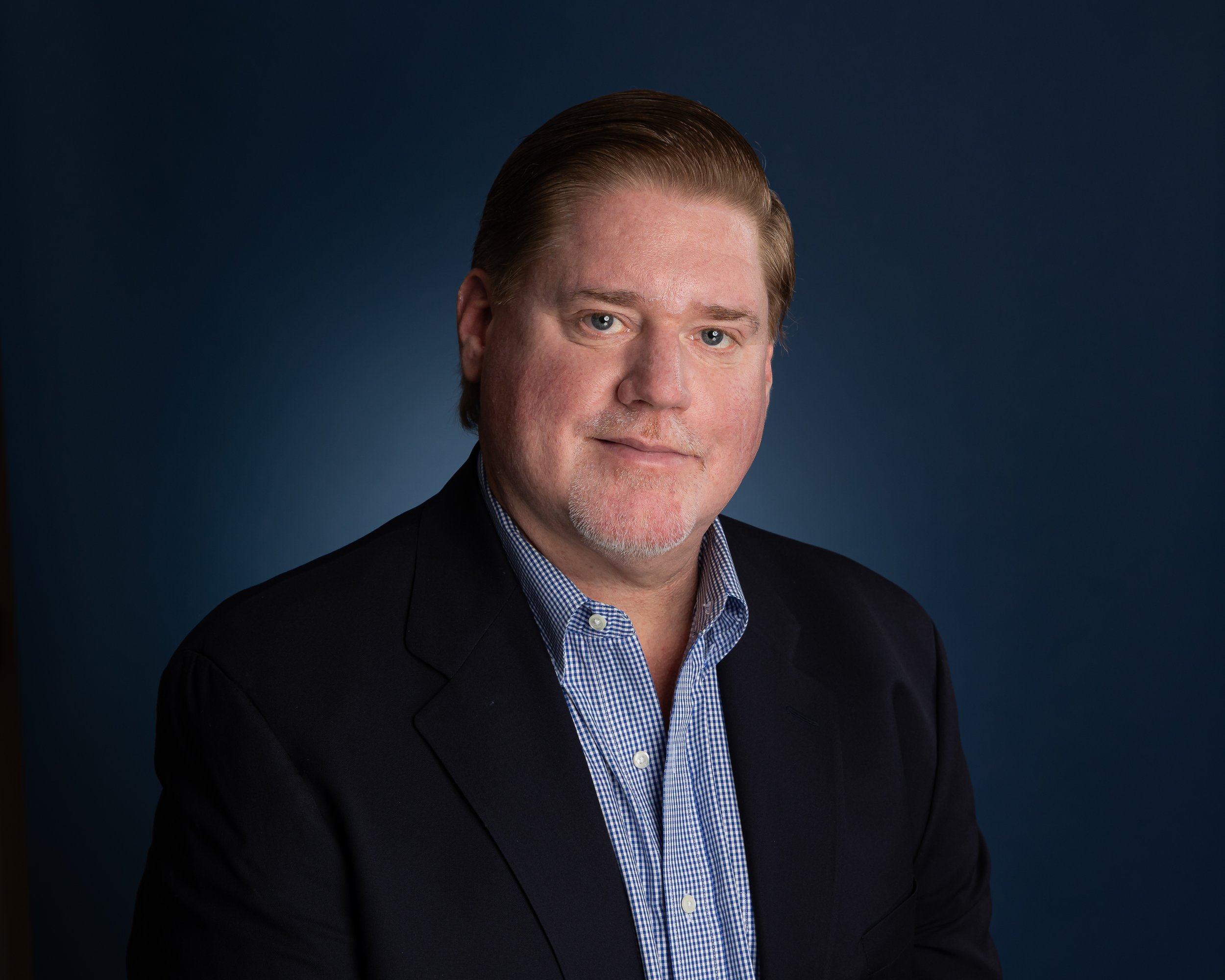 Professional business headshot with blue background and blue blazer  in Verona NJ by Matthew Ippolito Photography