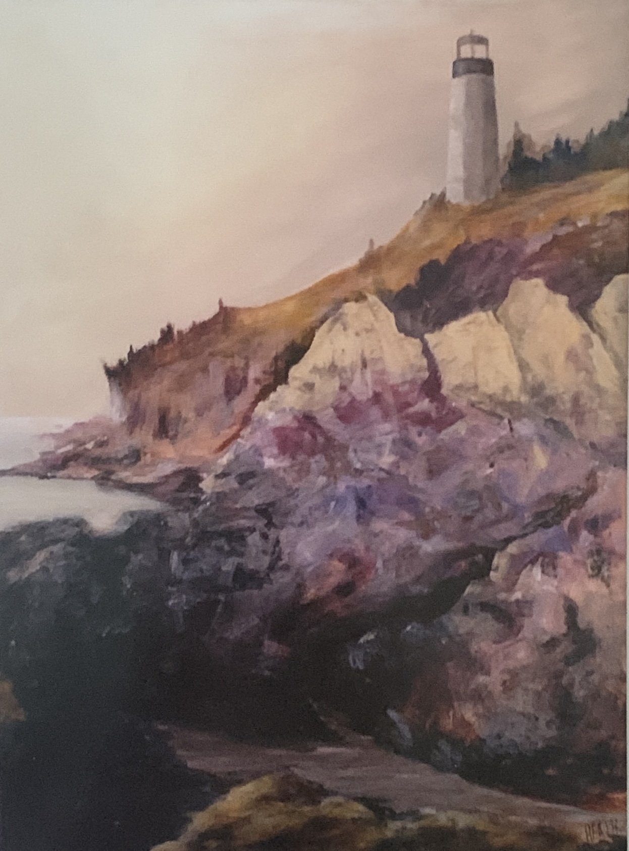 A lighthouse on a rocky, colorful cliff overlooking the ocean.