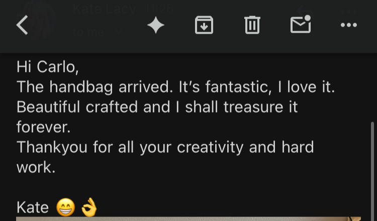 Screenshot of an email expressing excitement about a handbag, describing it as beautiful and crafted, and thanking the recipient for their creativity and hard work, signed by Kate with a smiling emoji and an OK hand sign.