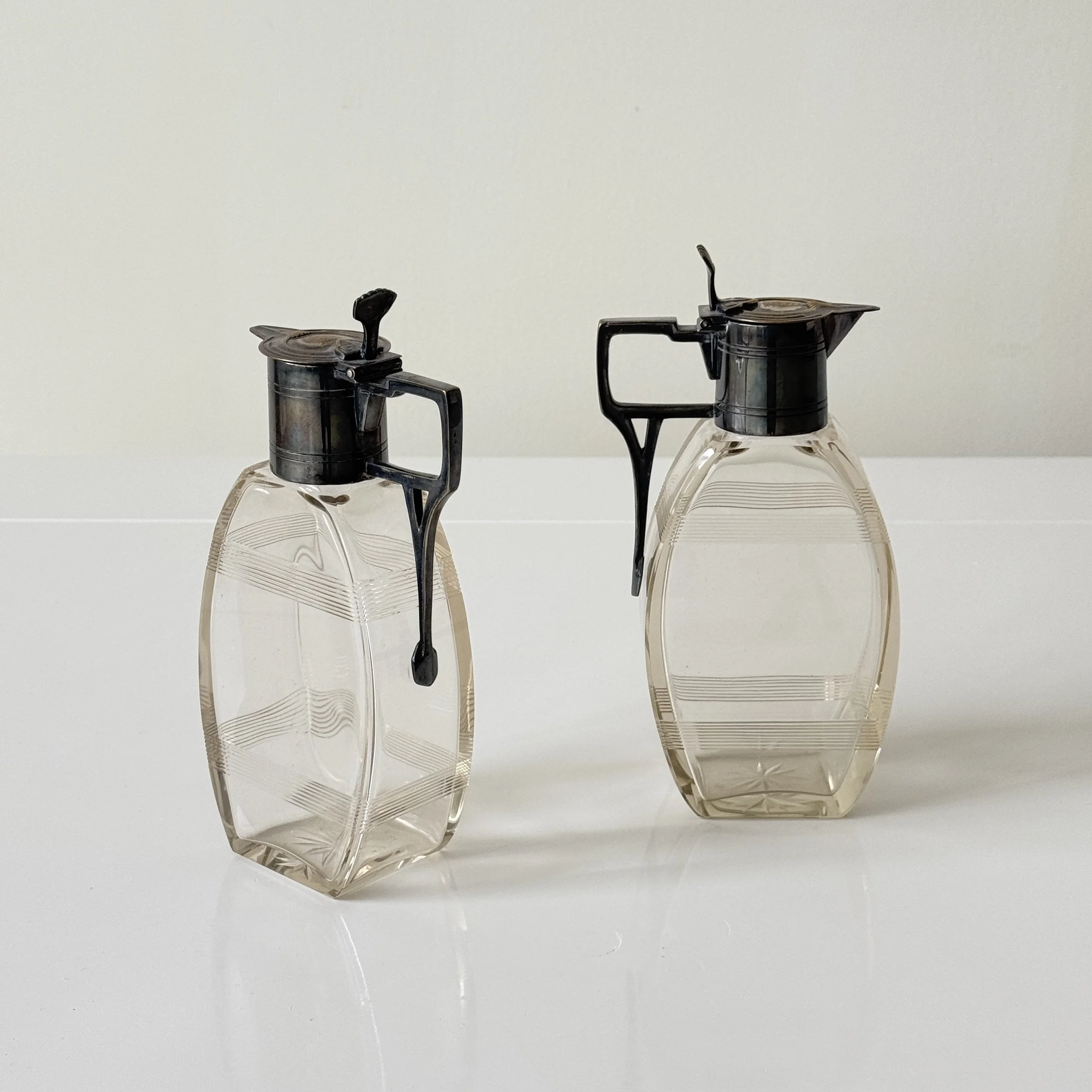 Pair of lidded carafes, probably produced in Germany or Austria, circa 1910