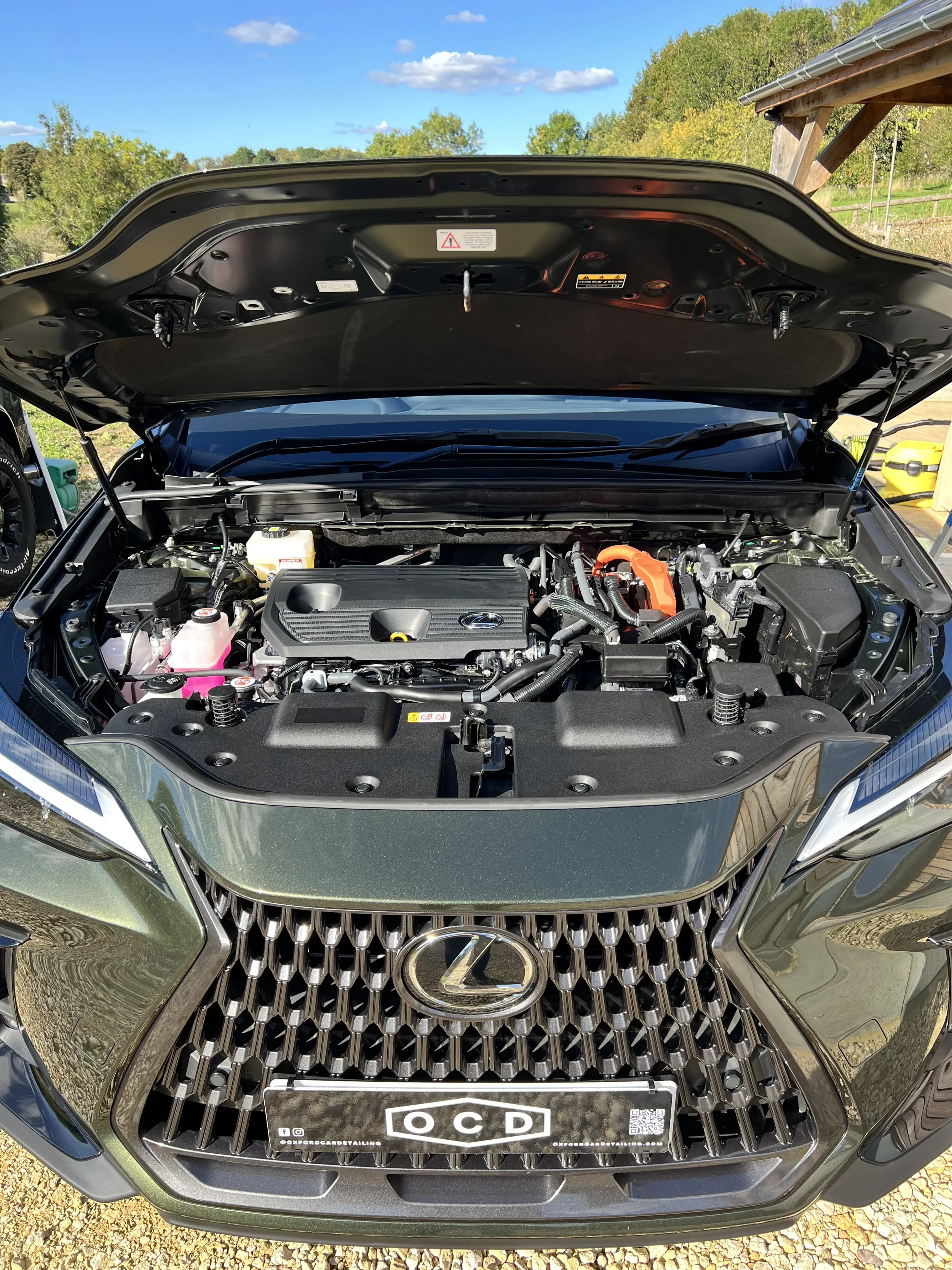 Front of a green Lexus car with the hood open after full detail and engine bay valet by Oxford Car Detailing.