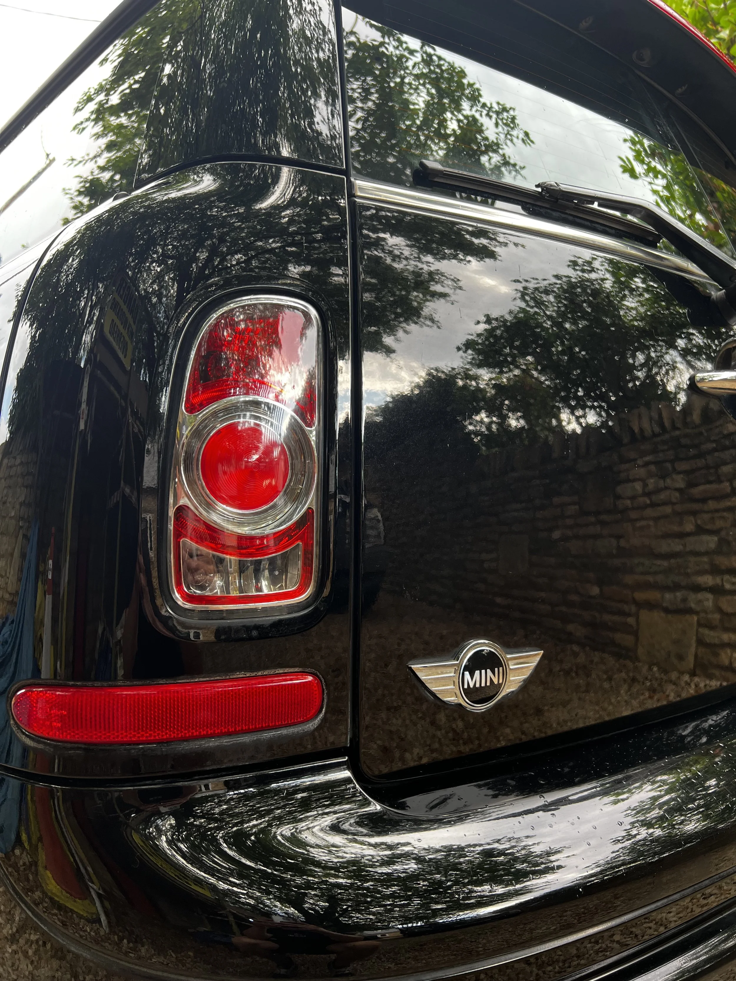 Close-up of the rear of a black Mini Cooper car after OCD car valet and detailing package