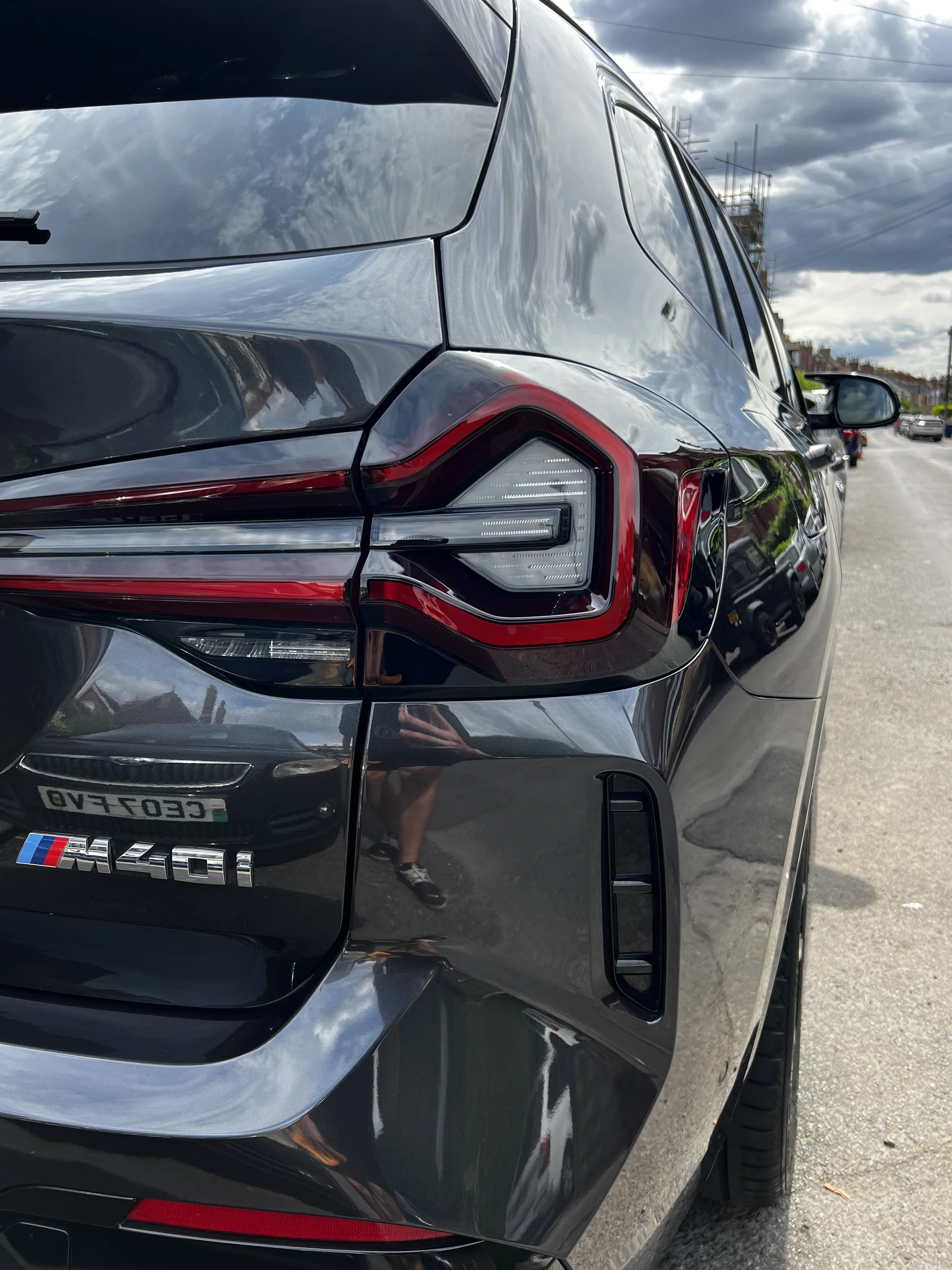 Rear view of a black BMW M40i vehicle after full detailing valet.
