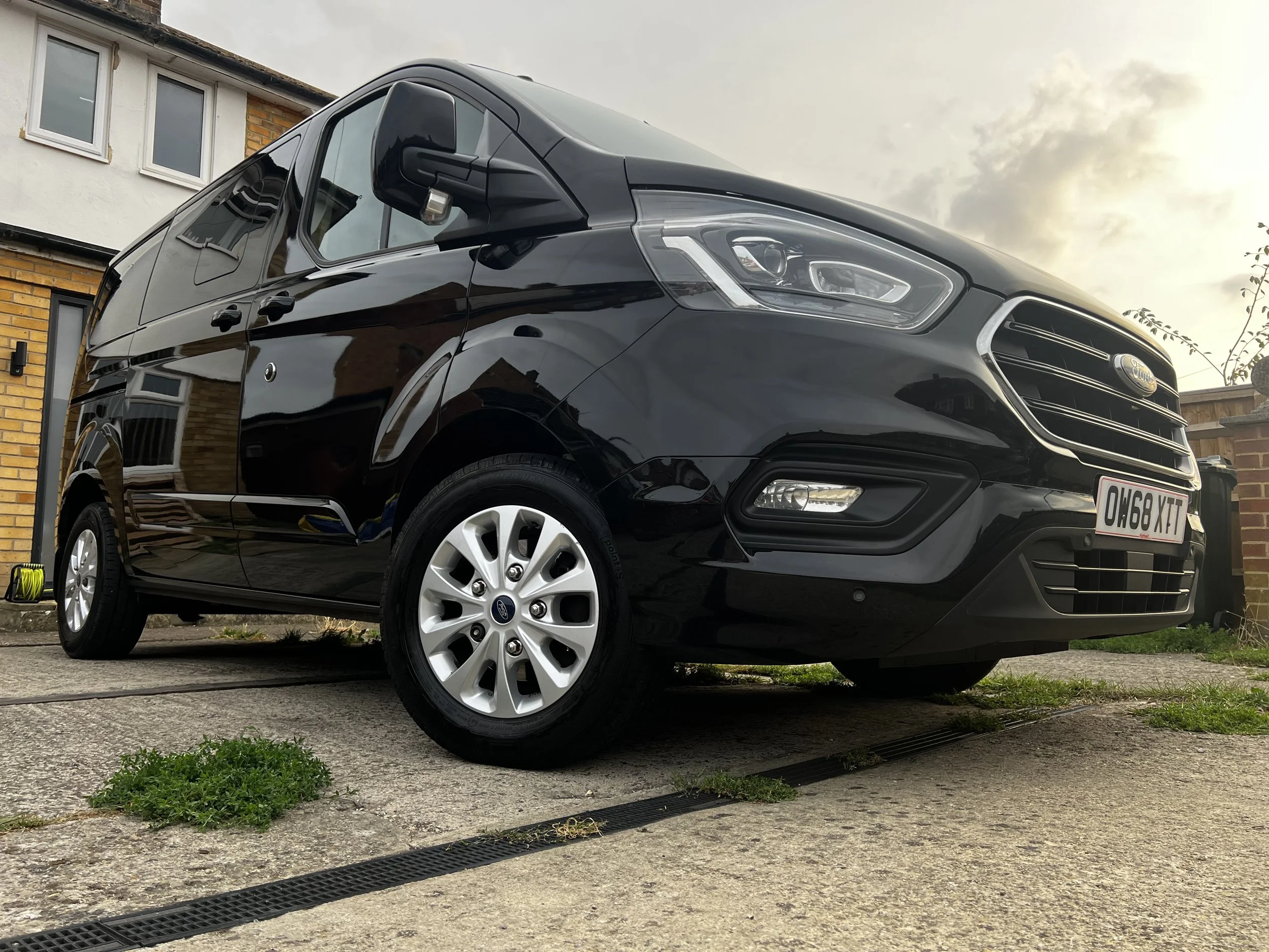 A black Ford Transit Connect van after a full detail valet by Oxford Car Detailing.