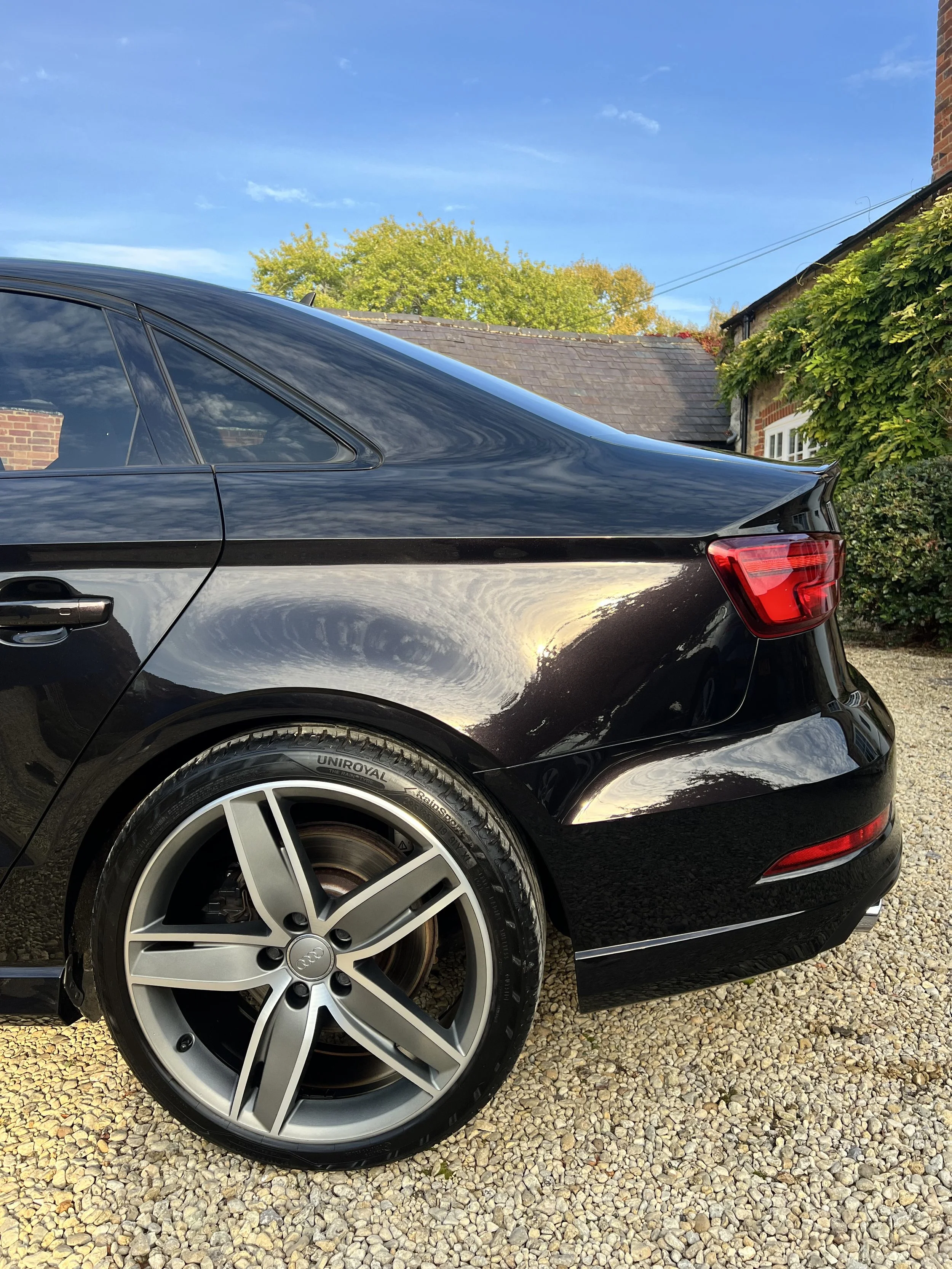 Close-up of the rear side of a black Audi after full valet and detail and ceramic coating.