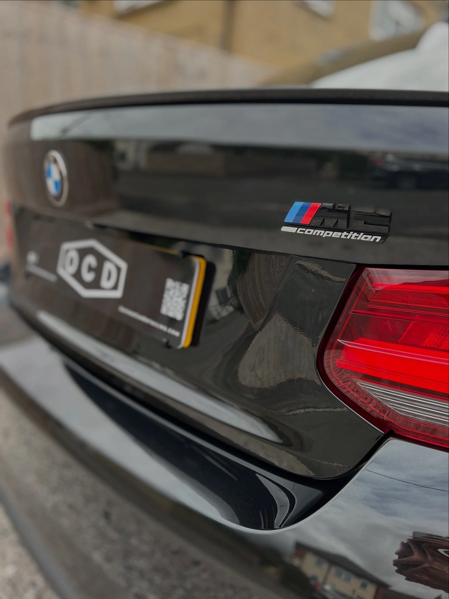 Black BMW car with M performance badge after mobile detailing and valet treatment.