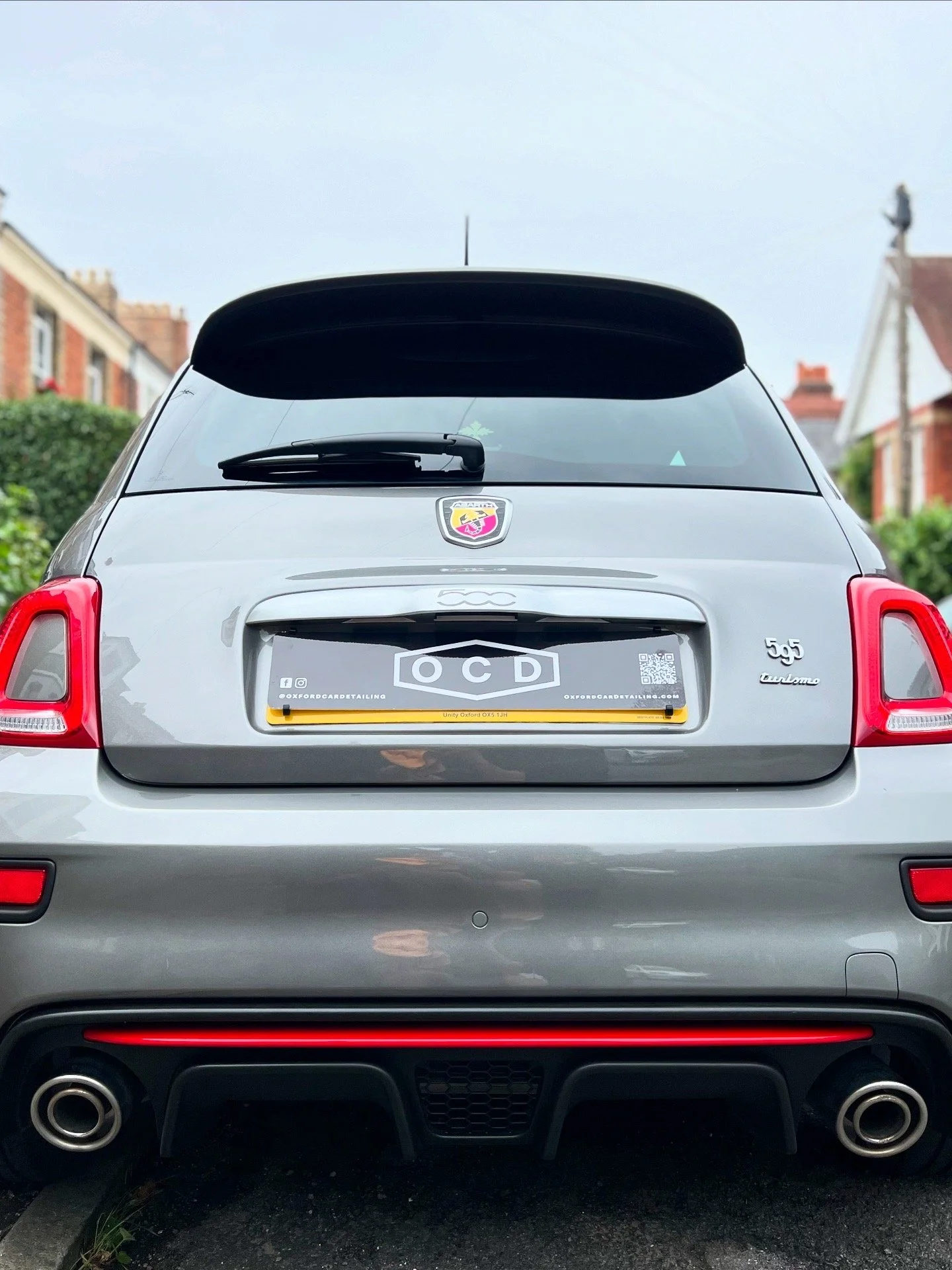Rear view of a silver car with a license plate that reads 'OCD' after OCD car valet and detailing package.