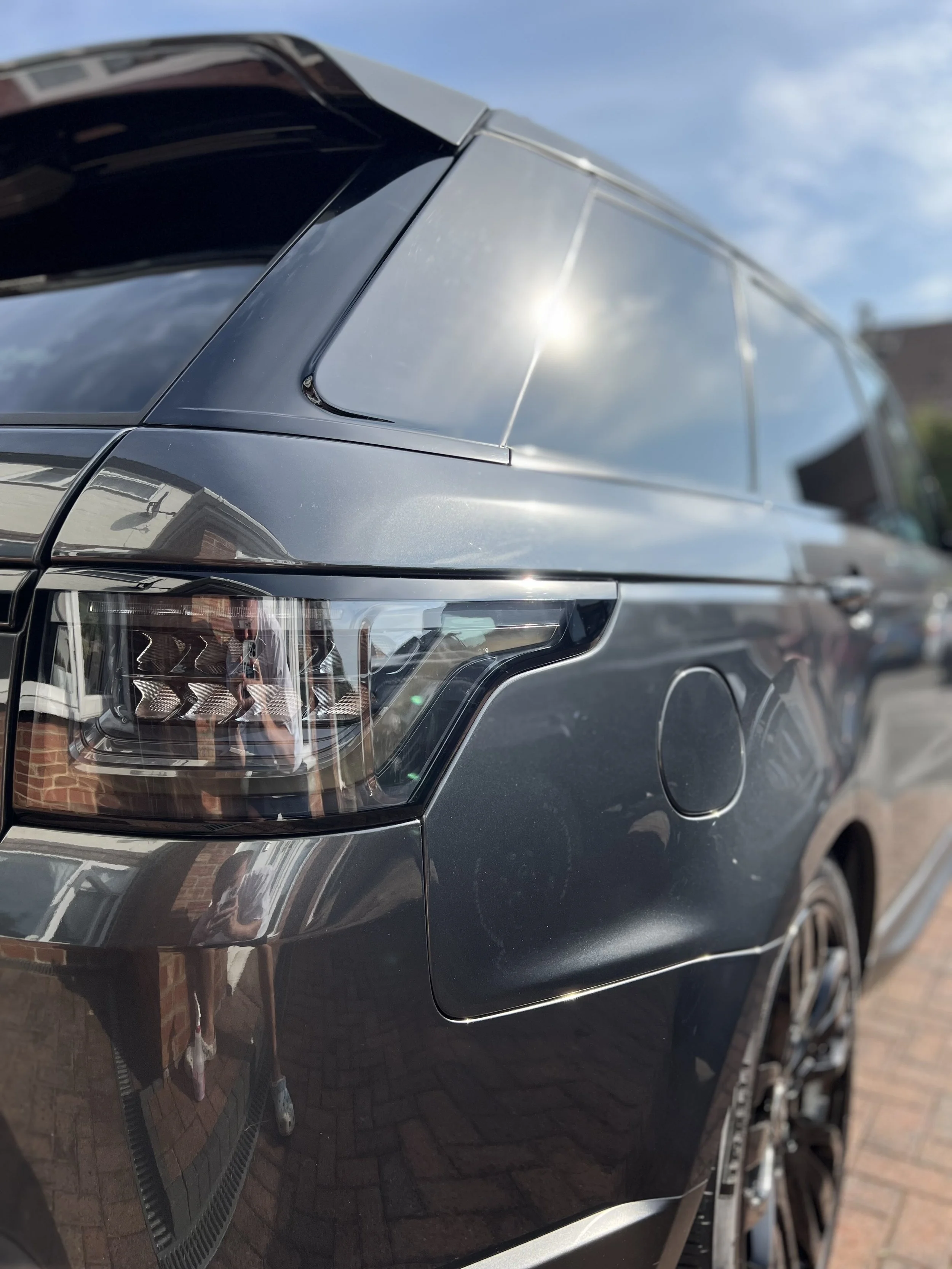 Close-up of the rear side of a black luxury SUV after full detailing valet.