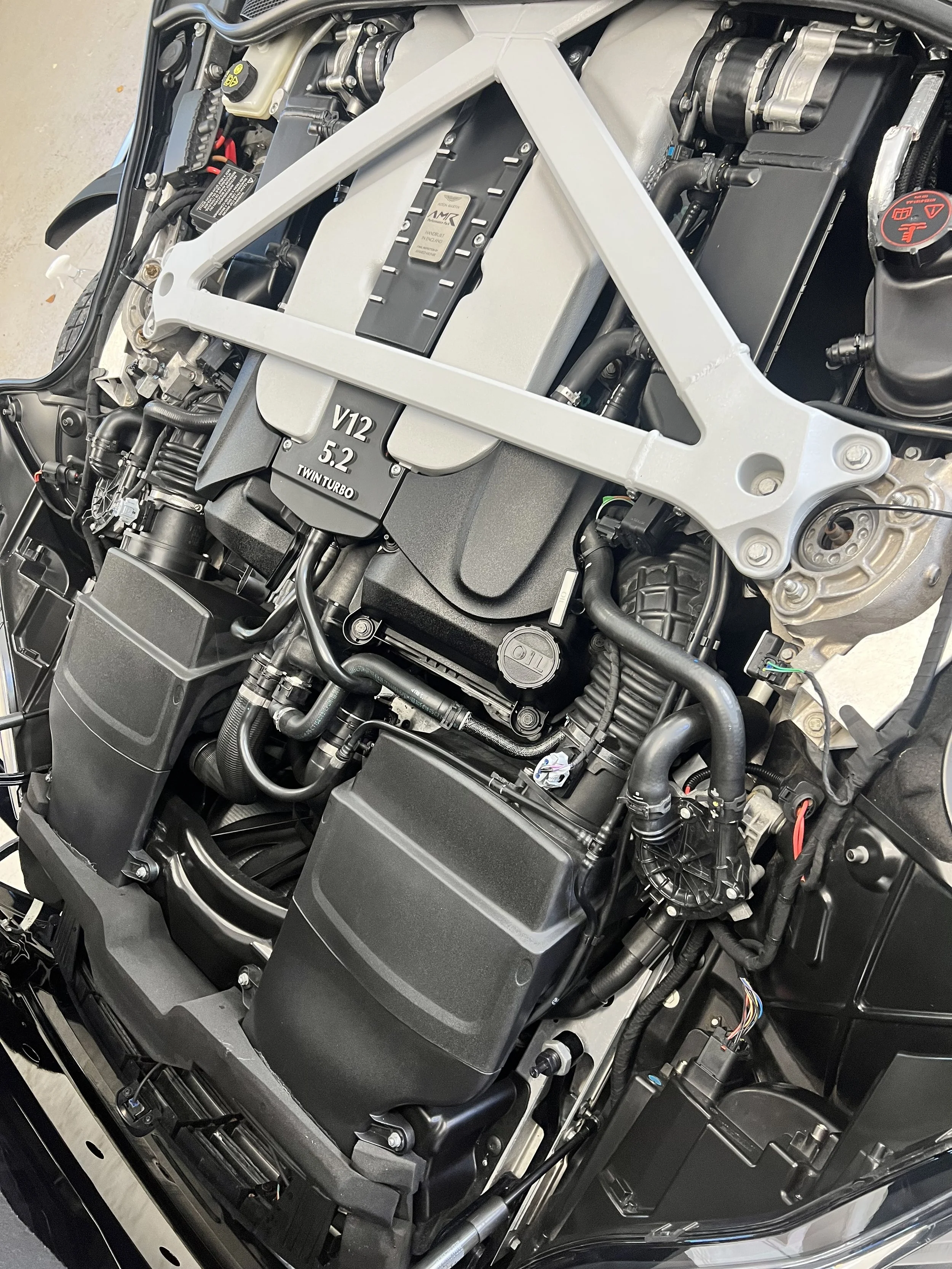 Aston Martin engine bay after full valet and detail and ceramic coating.