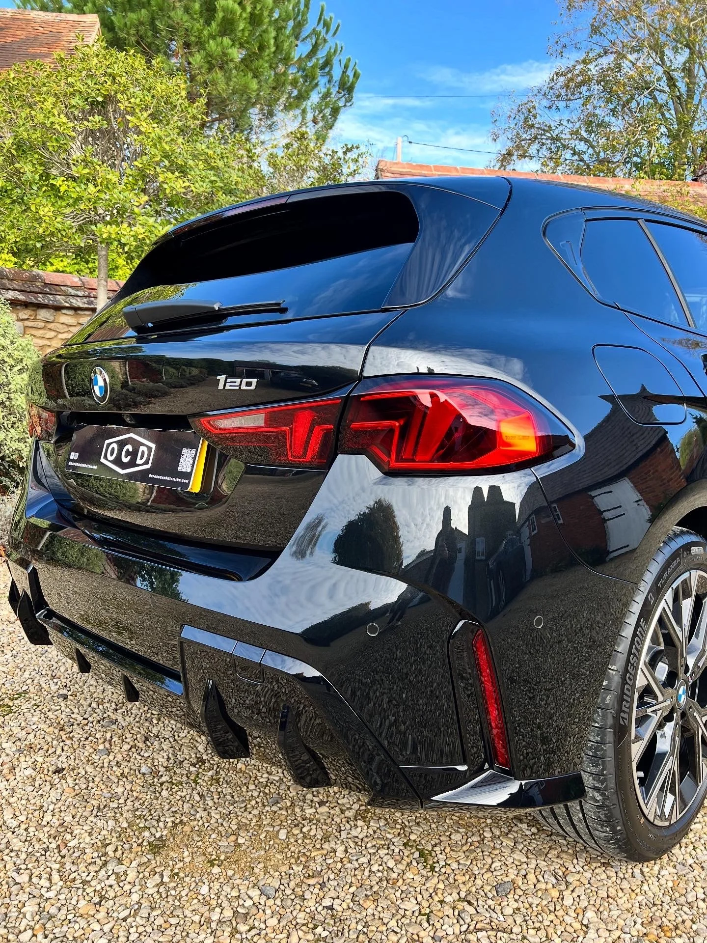 Rear view of a black BMW 120 car after full valet and detail and ceramic coating.