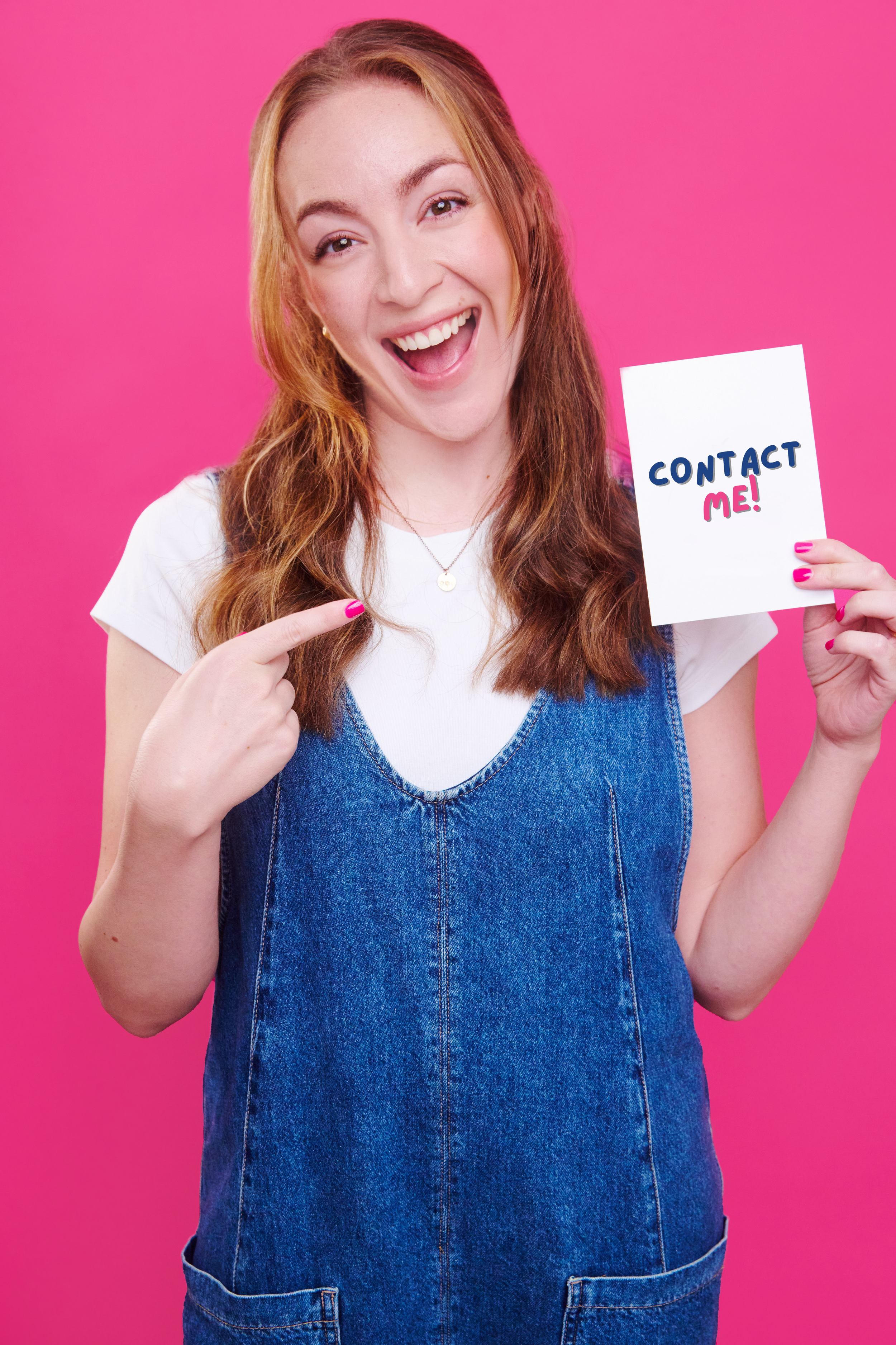 Young woman with blond hair pointing to a sign that says "Contact Me!" against a pink background.