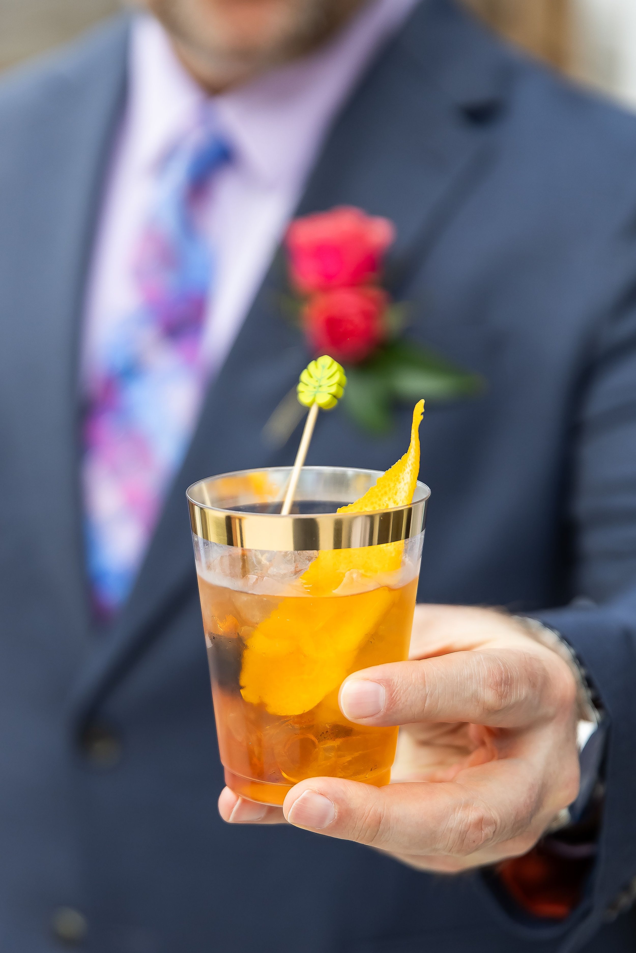 Bartender serving a signature craft cocktail at a private party in Austin TX