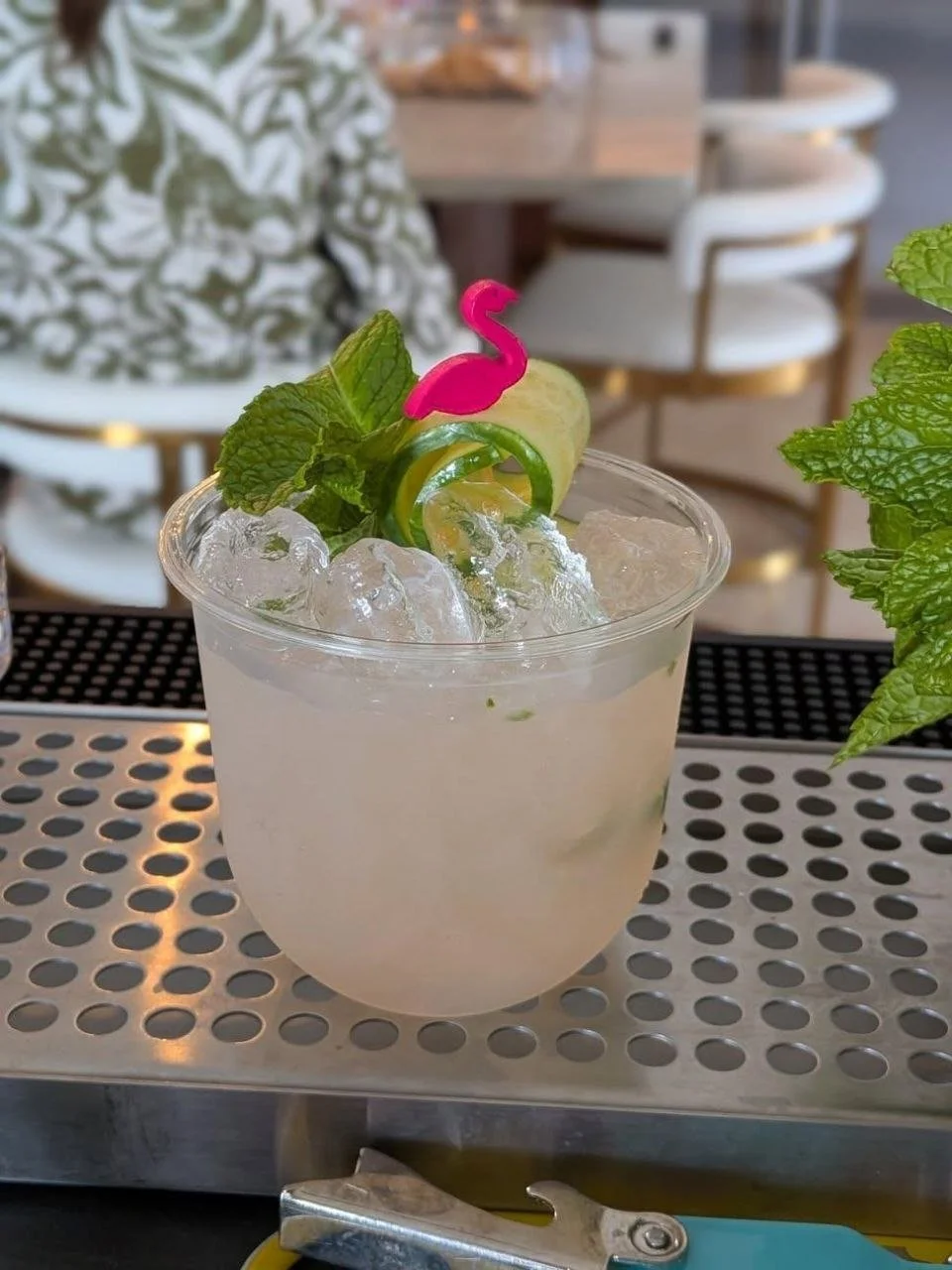 Social Butterfly ATX Island Wood Smash cocktail garnished with fresh mint, a cucumber ribbon, and a pink flamingo pick, served over crushed ice at an Austin mobile bar event