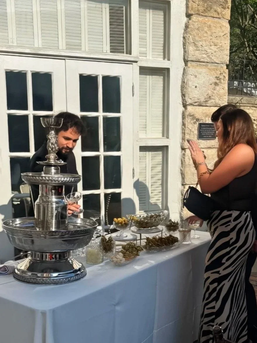 Tiered cocktail fountain with TABC-certified bartender at an Austin event