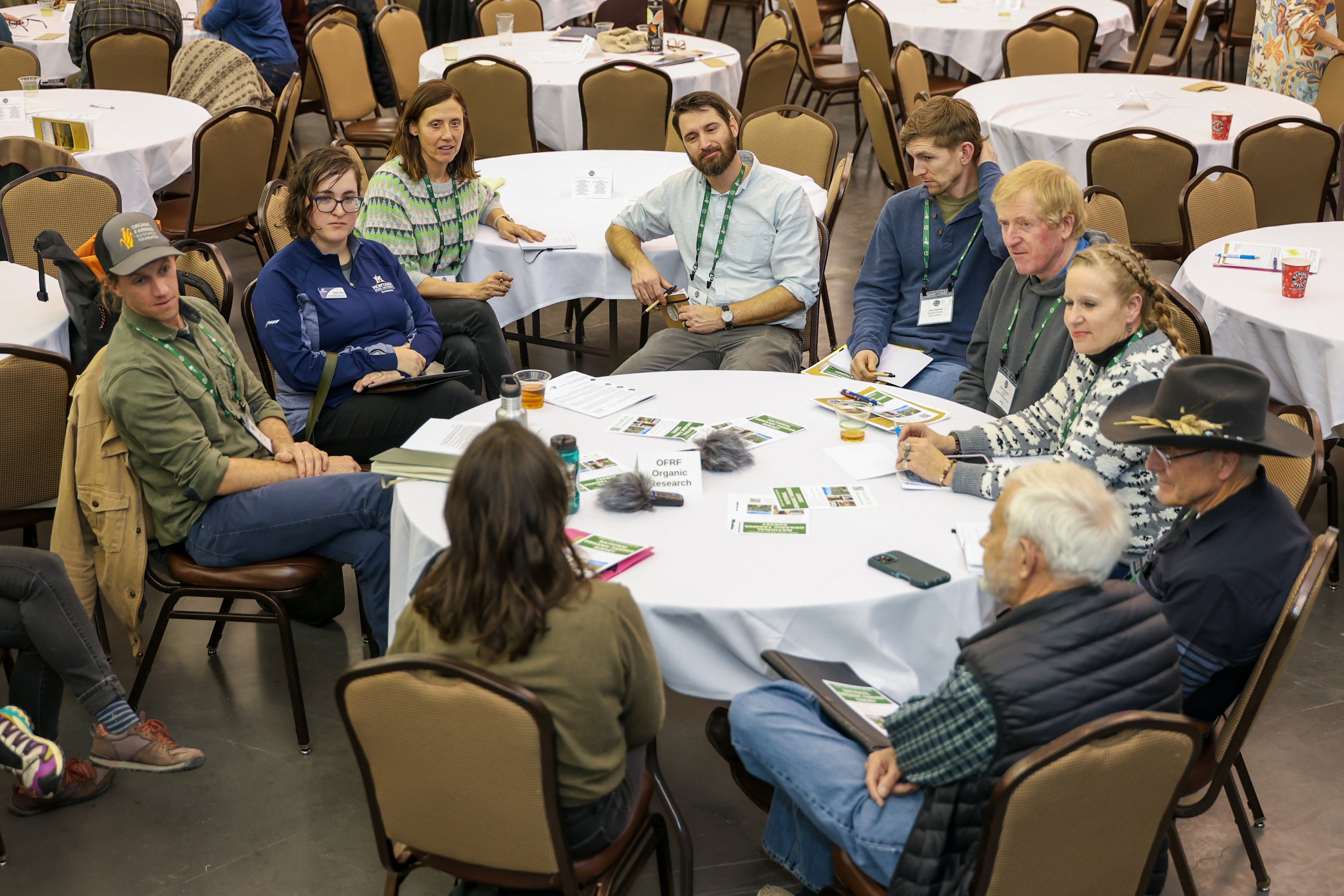 Conference attendees seated around a table