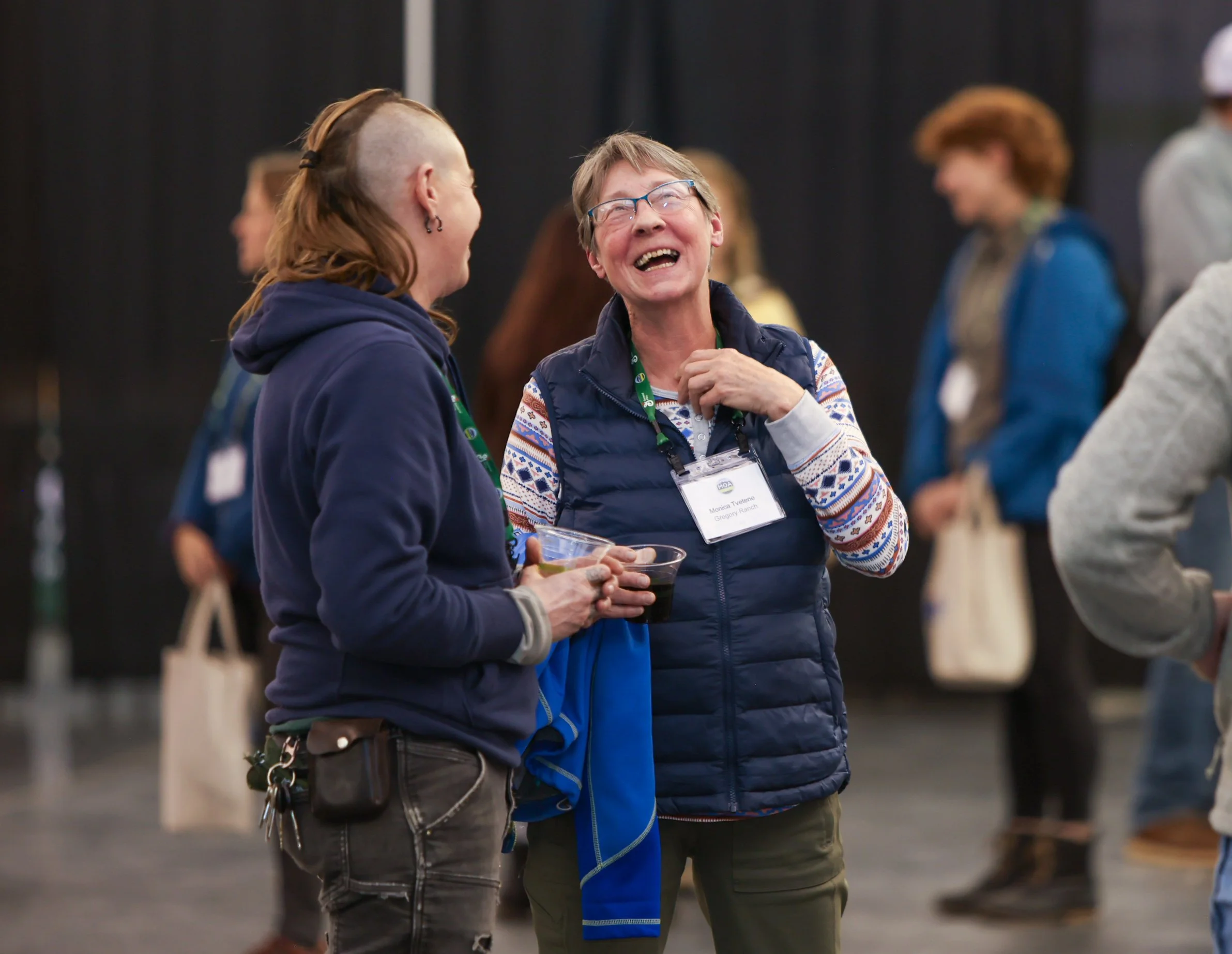 Two conference attendees laughing together