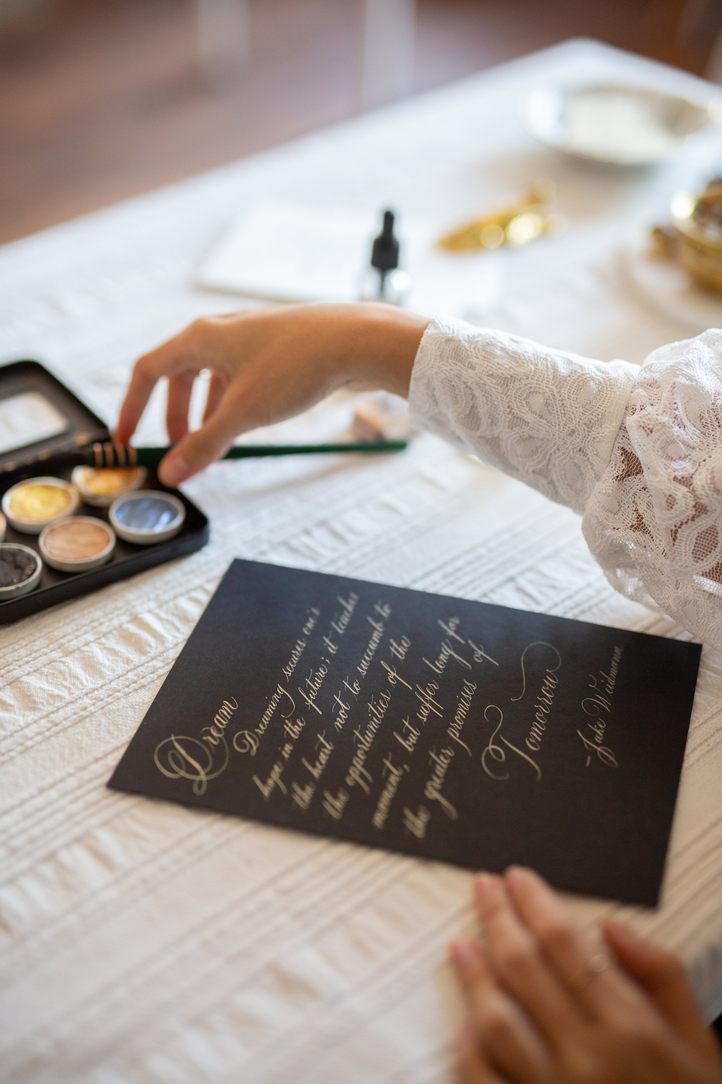Writing gold calligraphy on black paper